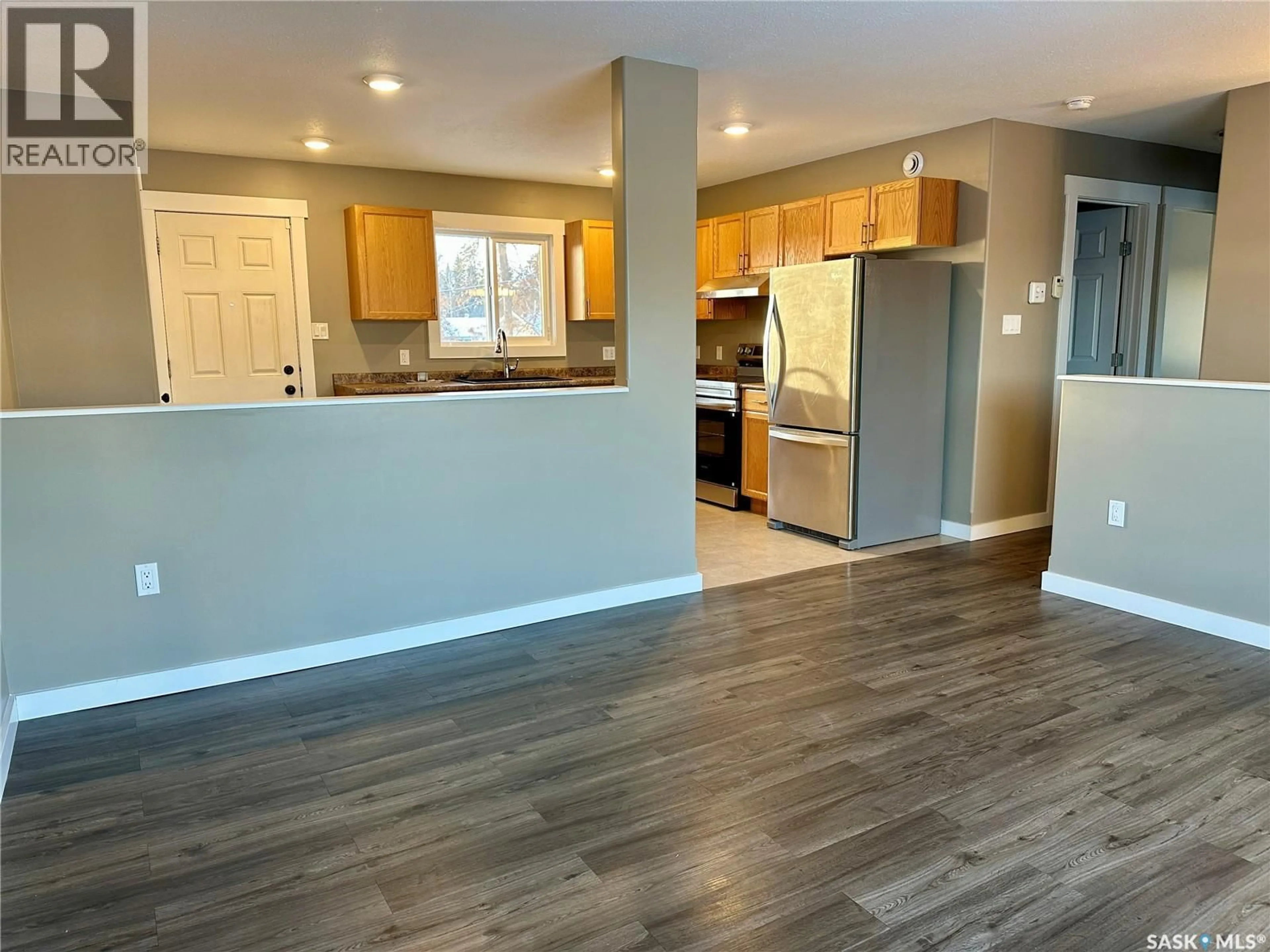 Open concept kitchen, wood/laminate floor for 595 COOK CRESCENT, La Ronge Saskatchewan S0J1L0