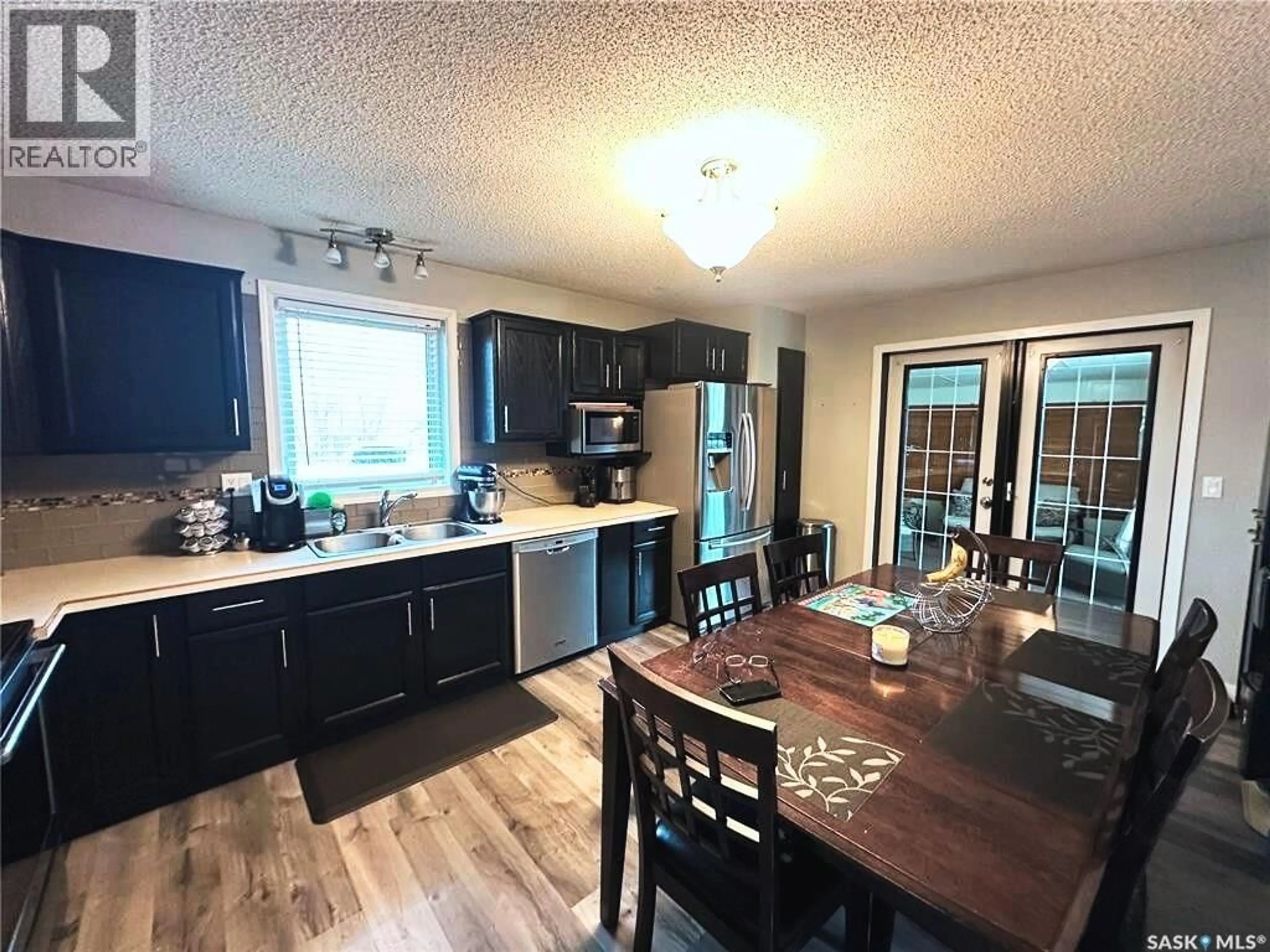 Open concept kitchen, wood/laminate floor for 331 4TH STREET, Weyburn Rm No. 67 Saskatchewan S0C1X0