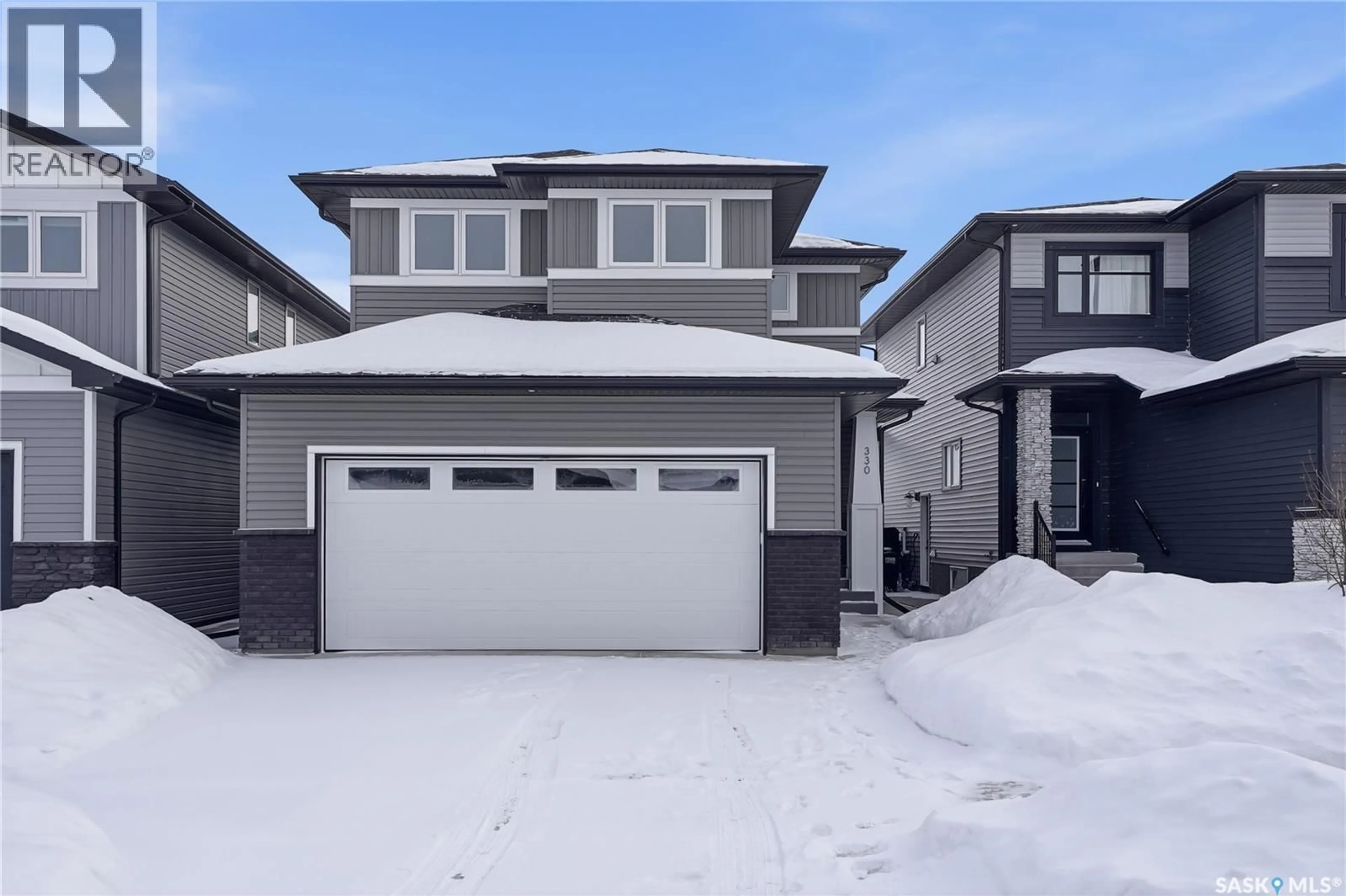 Home with vinyl exterior material, street for 330 ANISKOTAW BEND, Saskatoon Saskatchewan S7V1M1