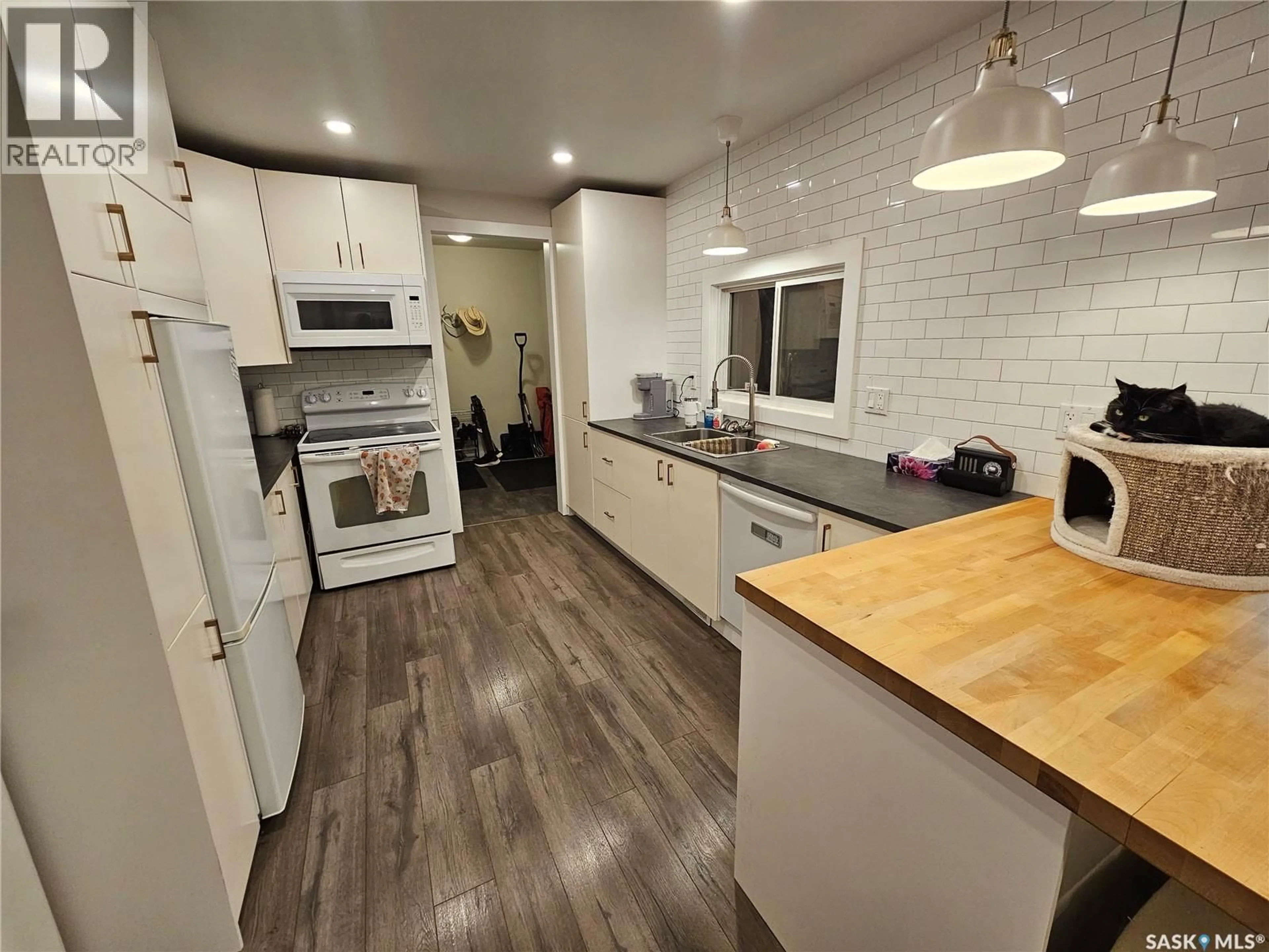 Open concept kitchen, wood/laminate floor for 608 1ST STREET, Meadow Lake Saskatchewan S9X1G1