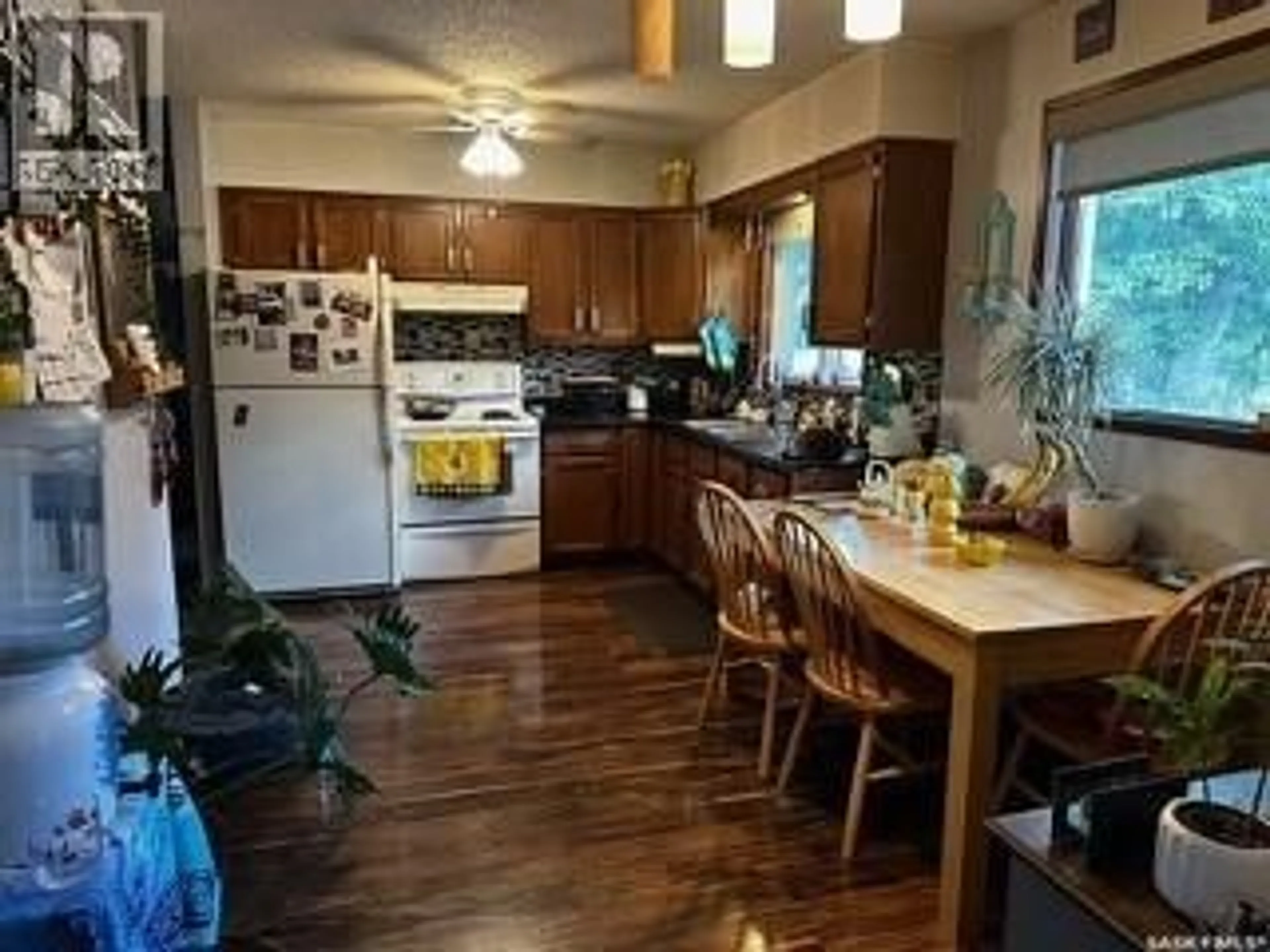 Open concept kitchen, wood/laminate floor for 110 SOUTH AVENUE E, Hafford Saskatchewan S0J1A0
