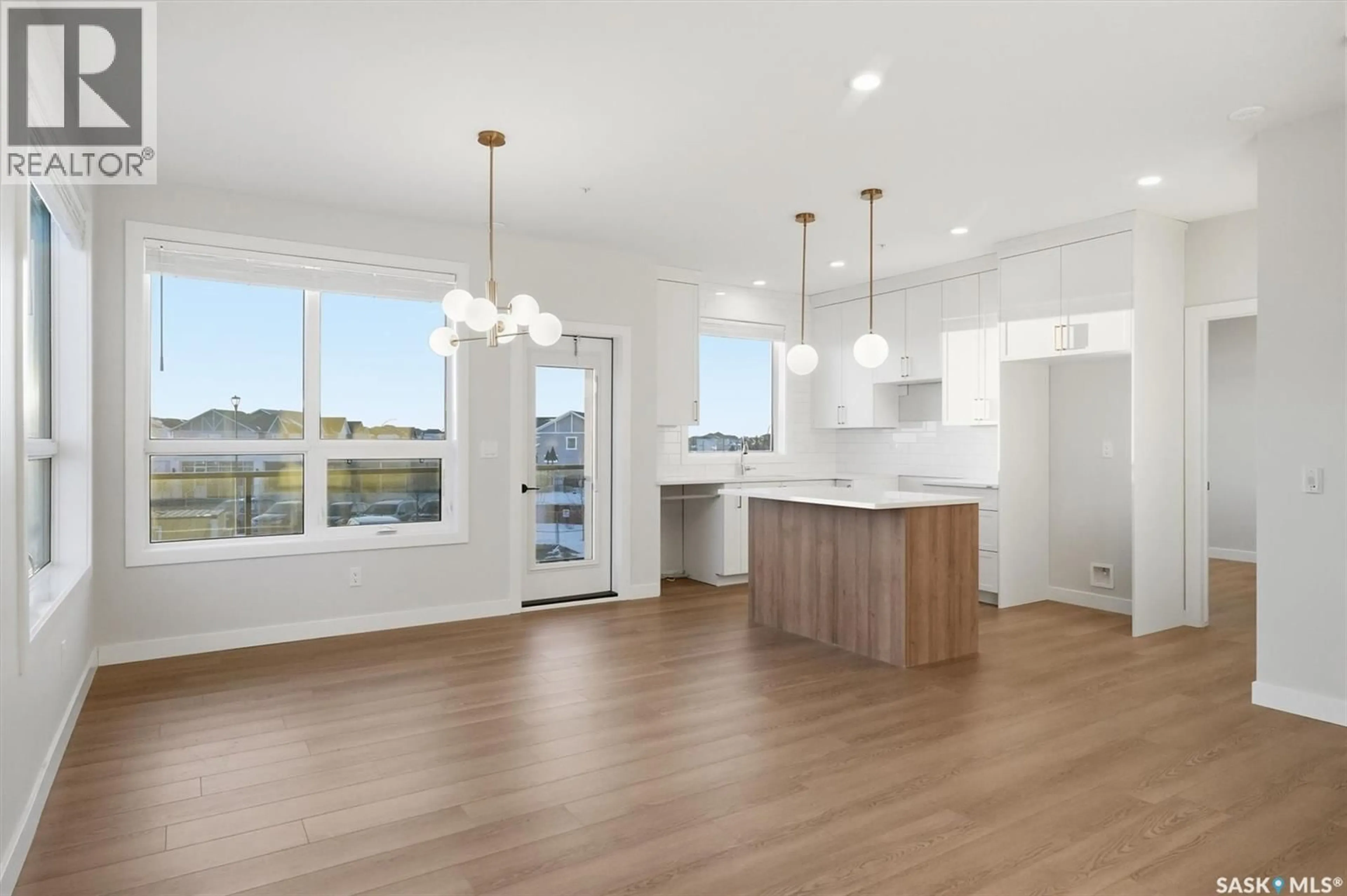Open concept kitchen, wood/laminate floor for 1201 101 SECORD WAY, Saskatoon Saskatchewan S7V1W6