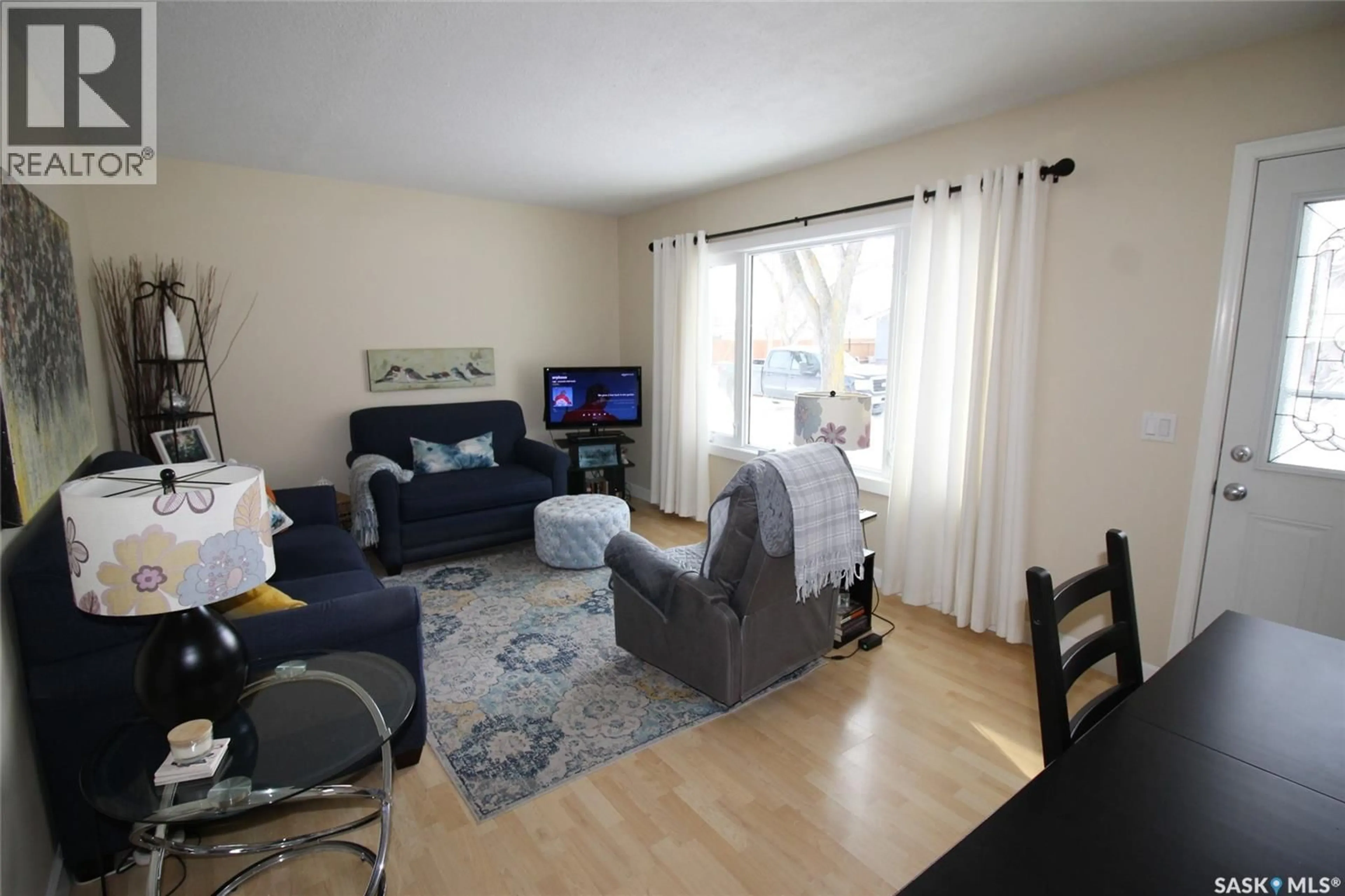 Living room with furniture, wood/laminate floor for 644 1ST STREET, Shaunavon Saskatchewan S0N2M0