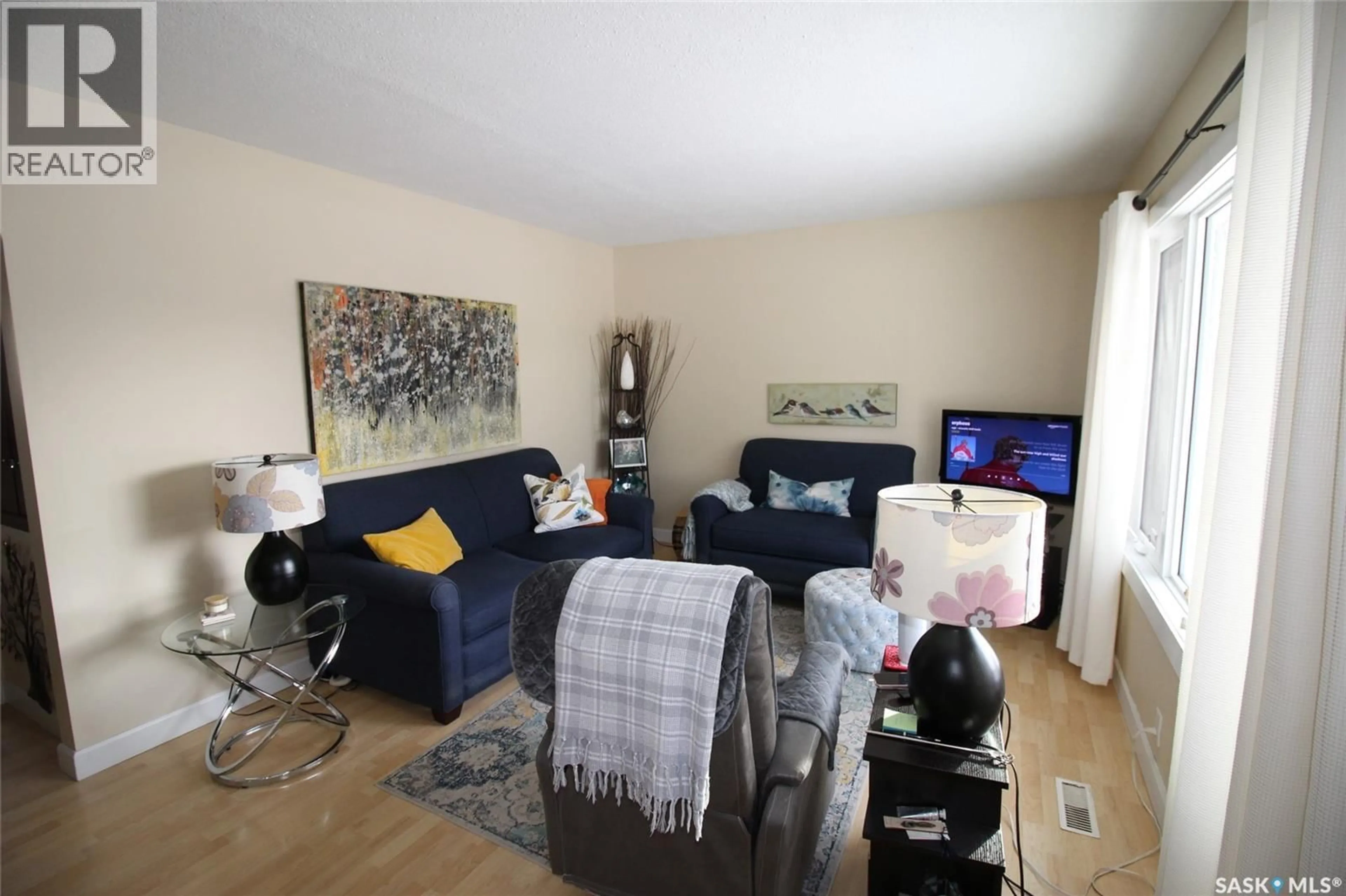 Living room with furniture, wood/laminate floor for 644 1ST STREET, Shaunavon Saskatchewan S0N2M0