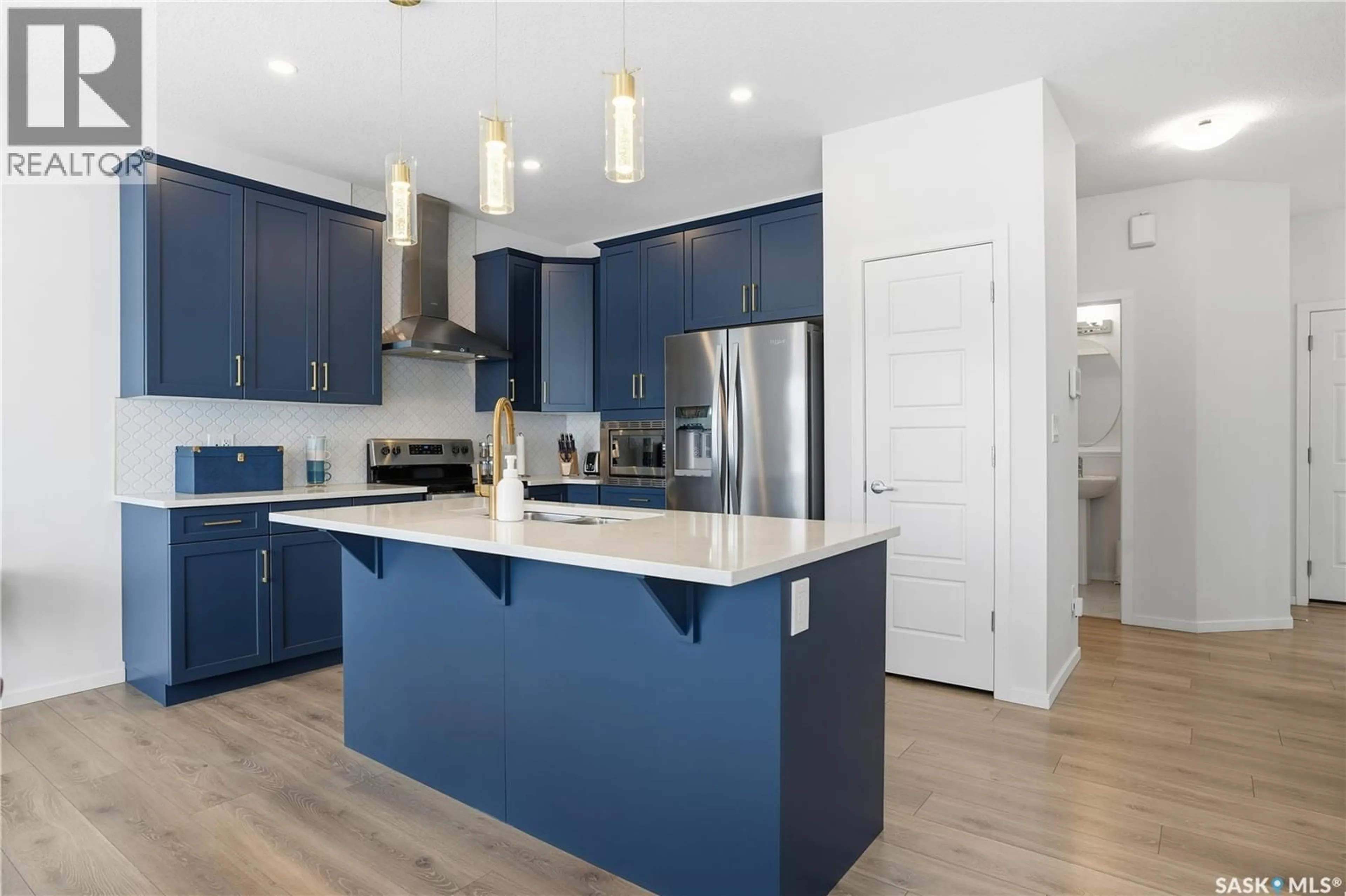 Open concept kitchen, wood/laminate floor for 3033 BELLEGARDE CRESCENT, Regina Saskatchewan S4V3W3