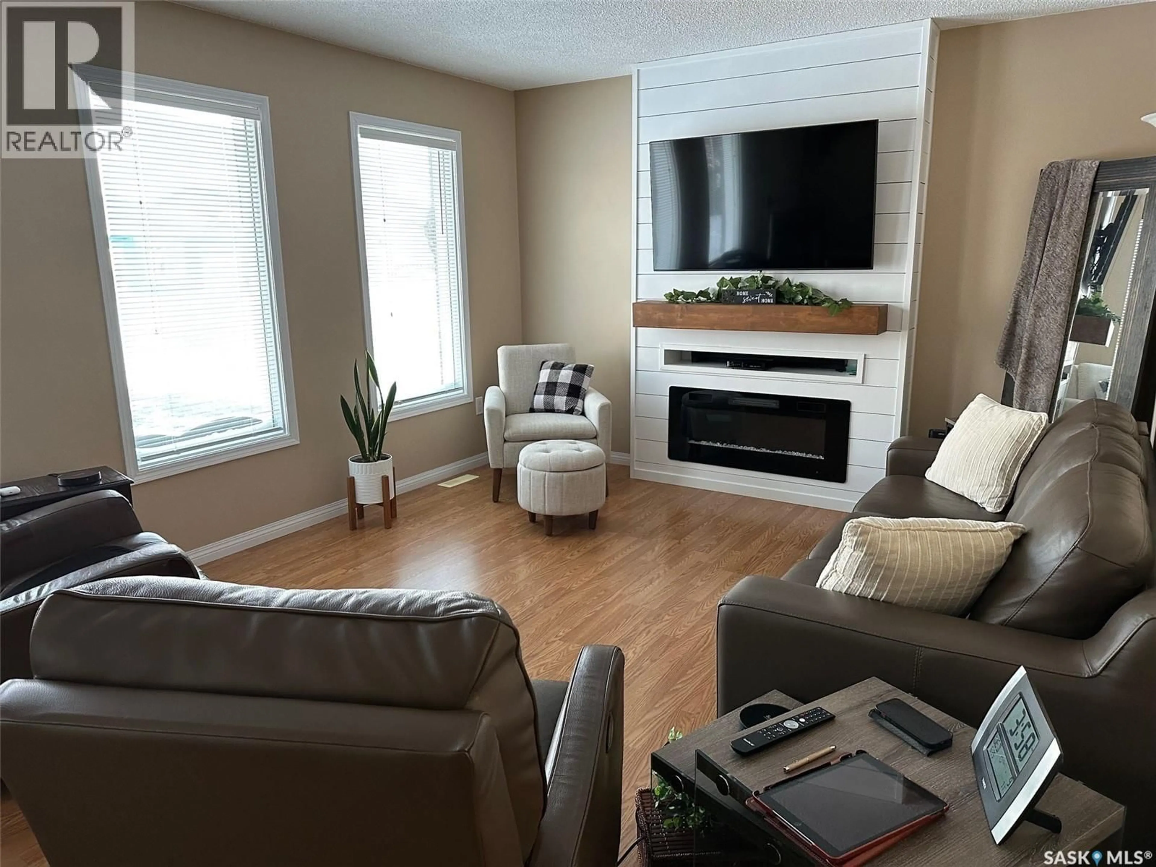 Living room with furniture, wood/laminate floor for 1483 MATHER CRESCENT, Estevan Saskatchewan S4A2J8