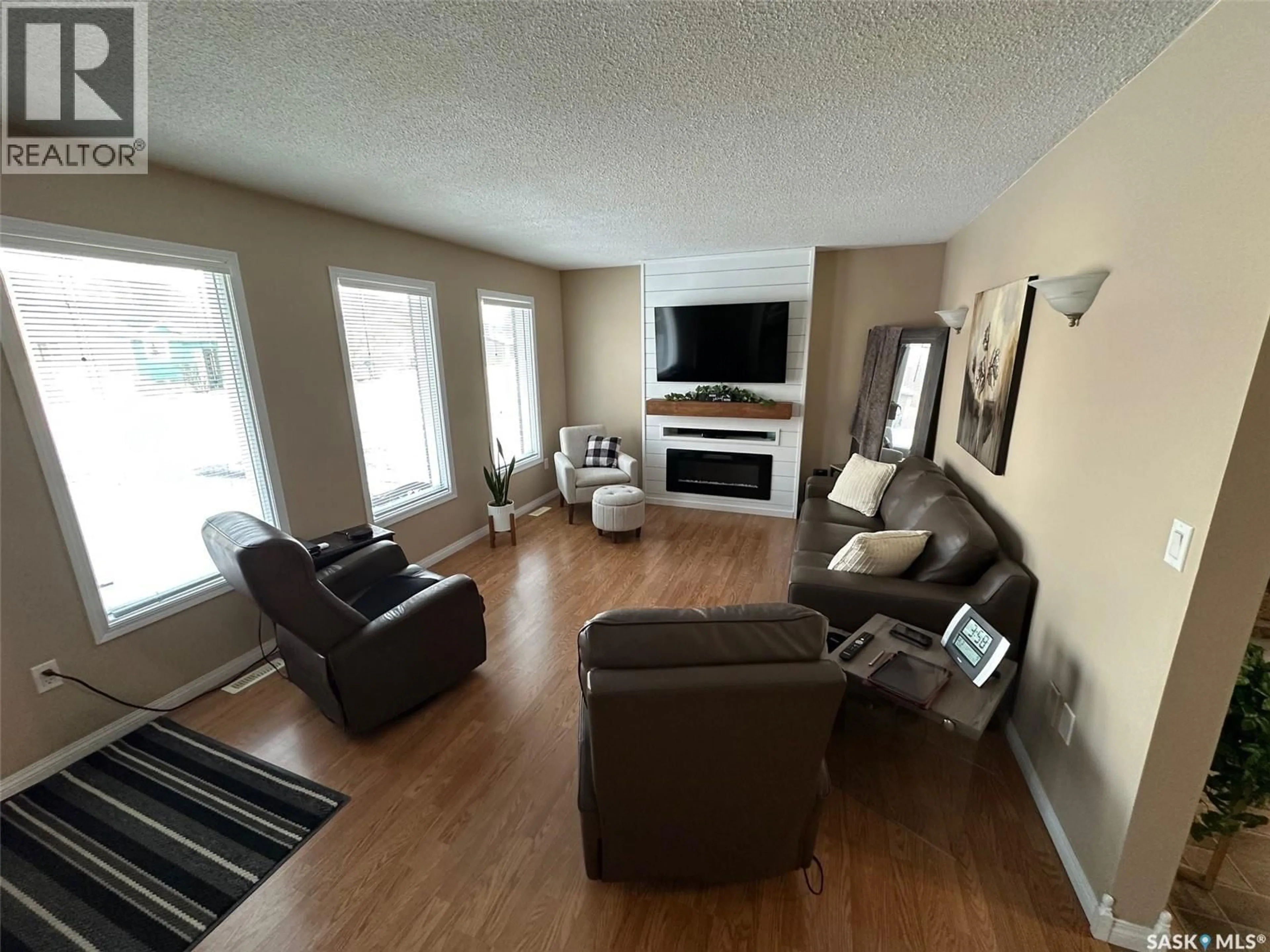 Living room with furniture, wood/laminate floor for 1483 MATHER CRESCENT, Estevan Saskatchewan S4A2J8