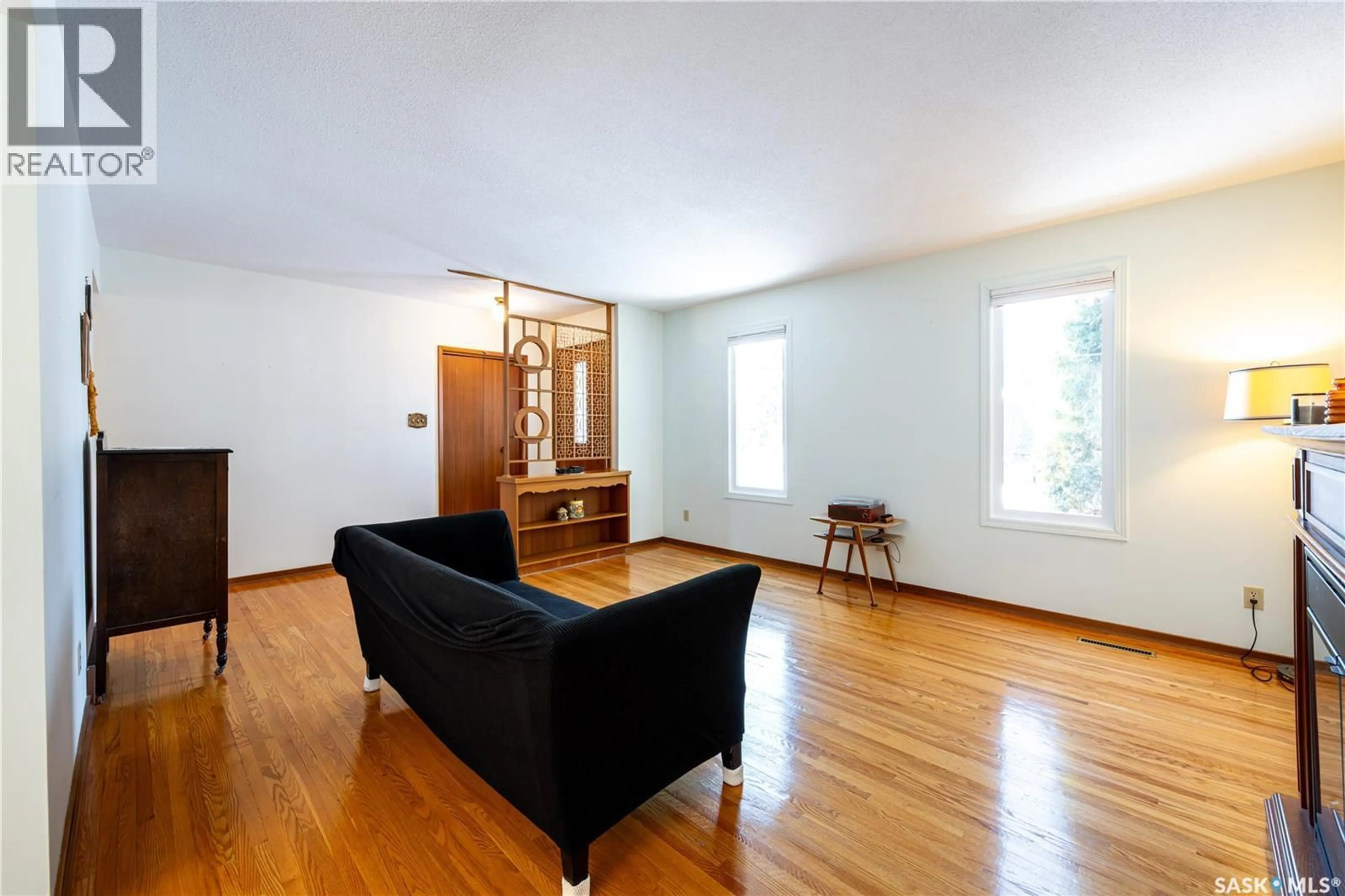 Living room with furniture, wood/laminate floor for 1305 CENTRE EAST, Saskatoon Saskatchewan S7J3A8