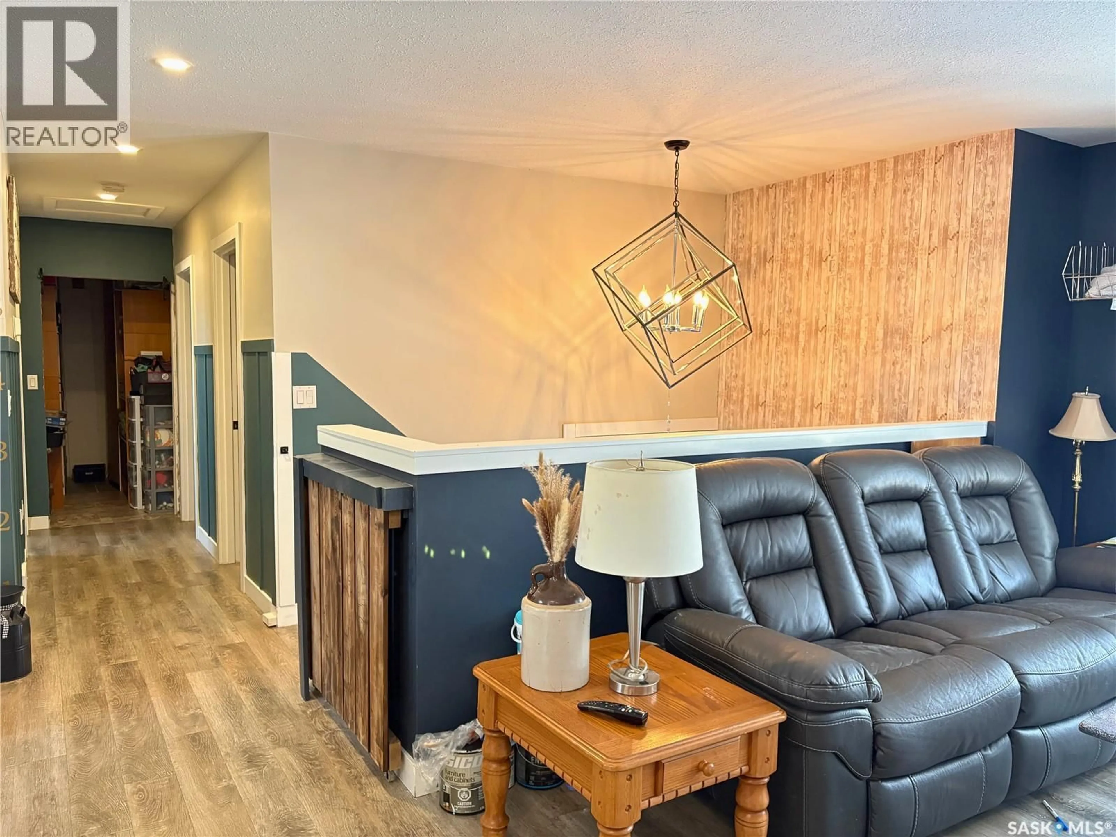 Living room with furniture, wood/laminate floor for 109 5TH STREET, Humboldt Saskatchewan S0K2A0