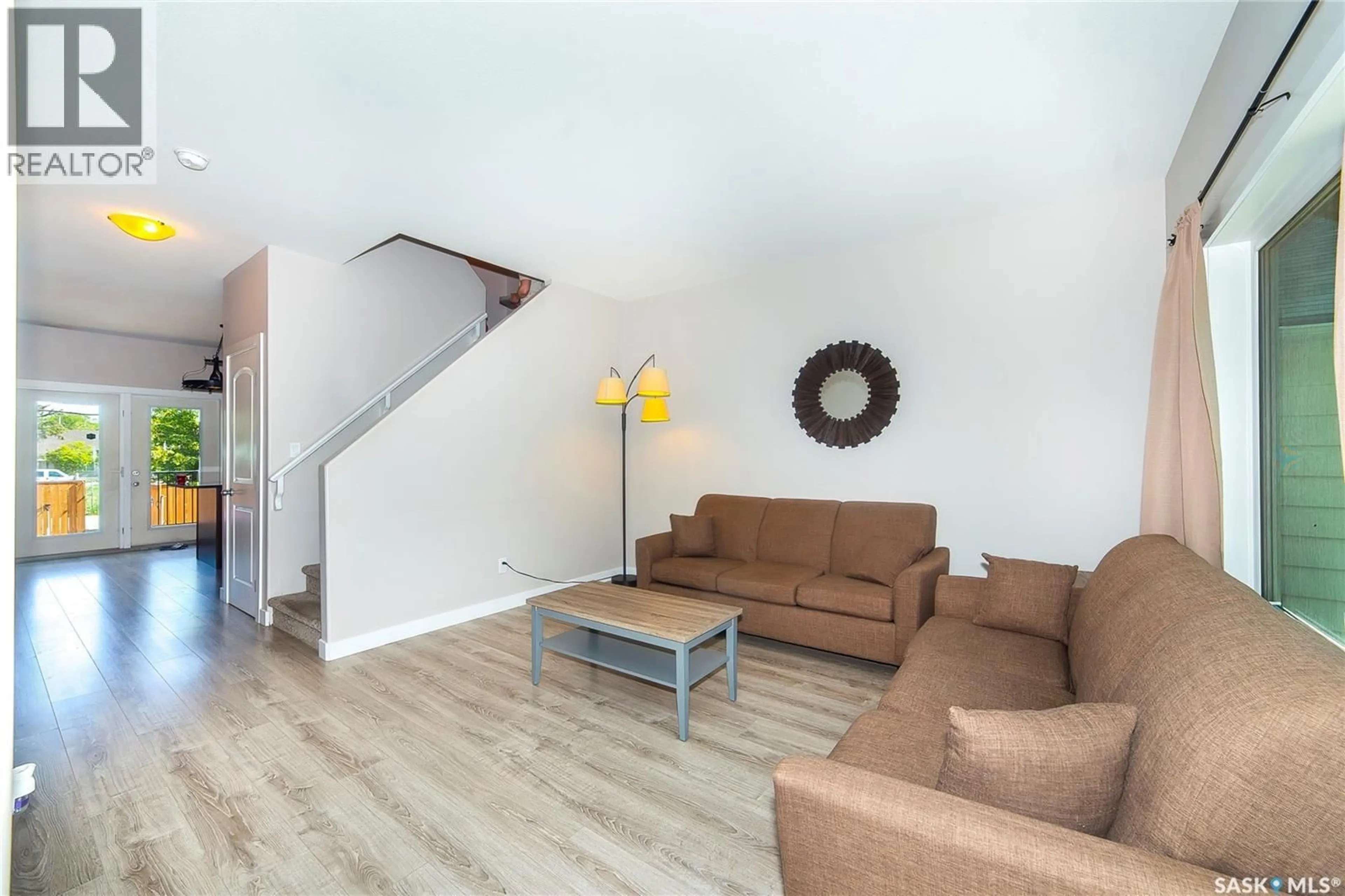 Living room with furniture, wood/laminate floor for 1320 B AVENUE, Saskatoon Saskatchewan S7L1G5