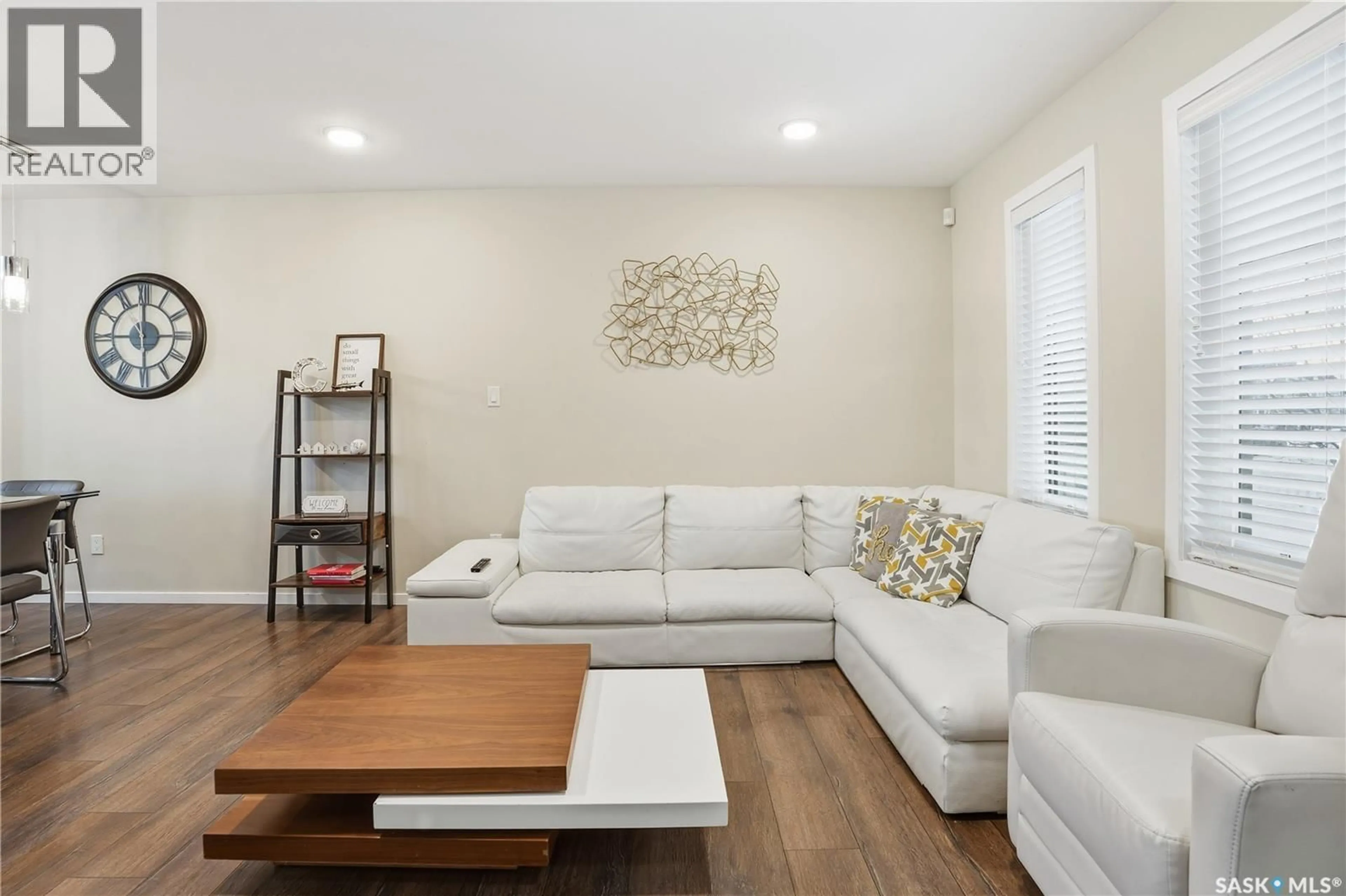 Living room with furniture, wood/laminate floor for 7904 CANOLA AVENUE, Regina Saskatchewan S4Y0E8