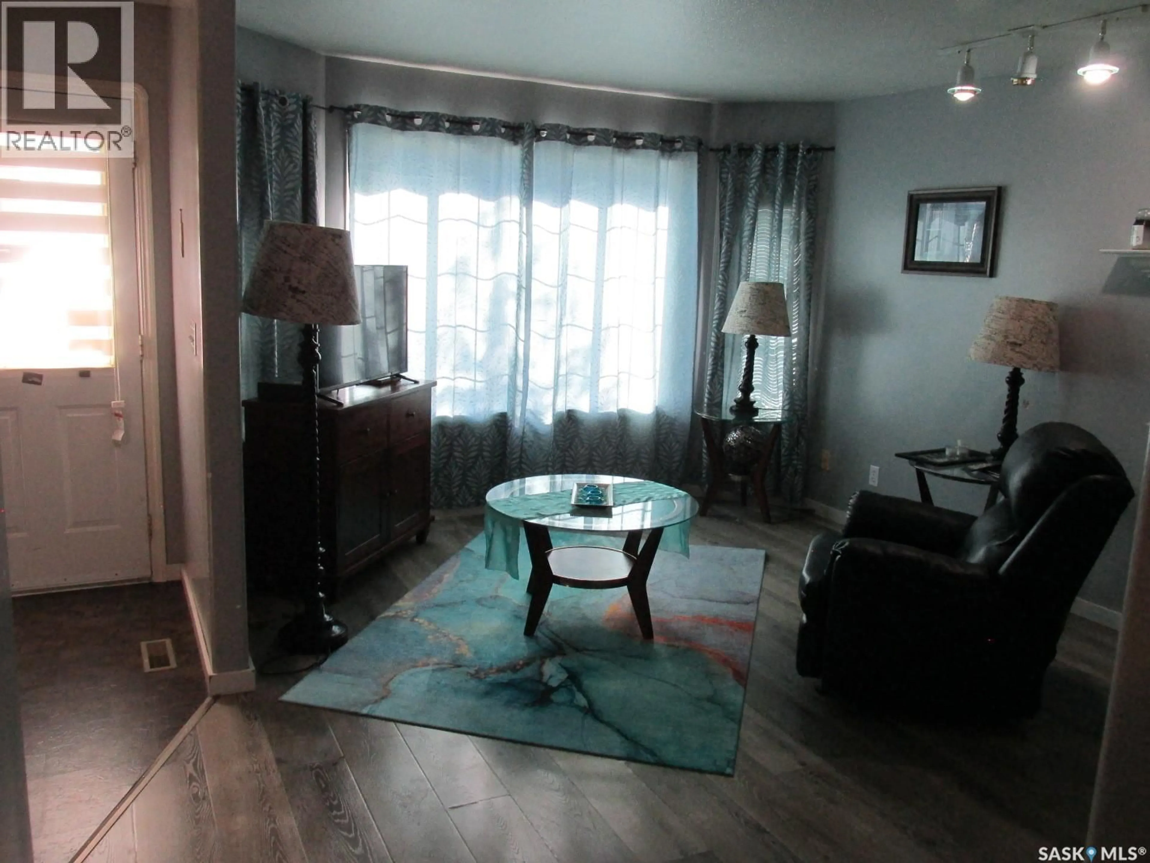 Living room with furniture, wood/laminate floor for 613 9TH AVENUE, Nipawin Saskatchewan S0E1E0