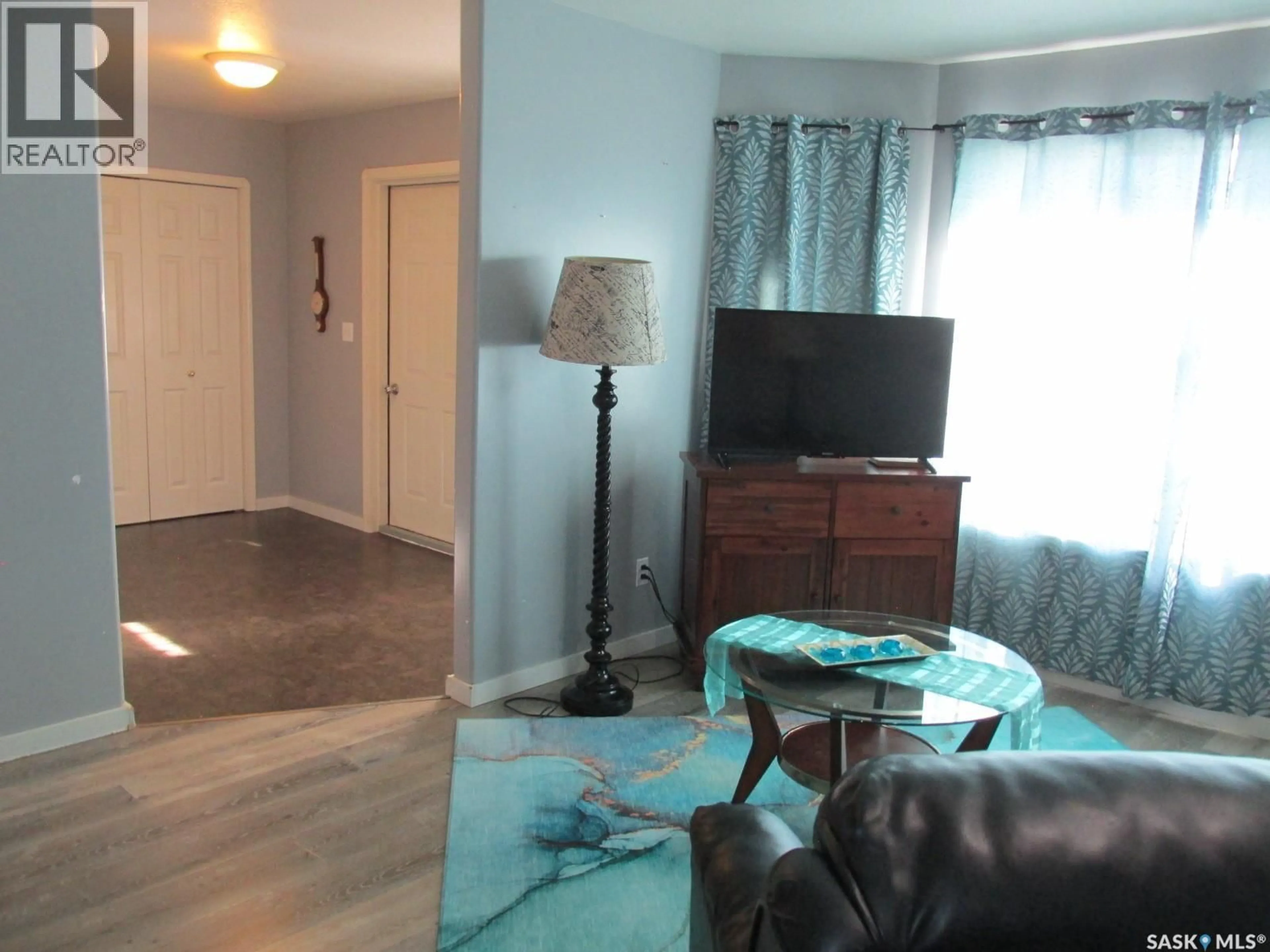 Living room with furniture, wood/laminate floor for 613 9TH AVENUE, Nipawin Saskatchewan S0E1E0