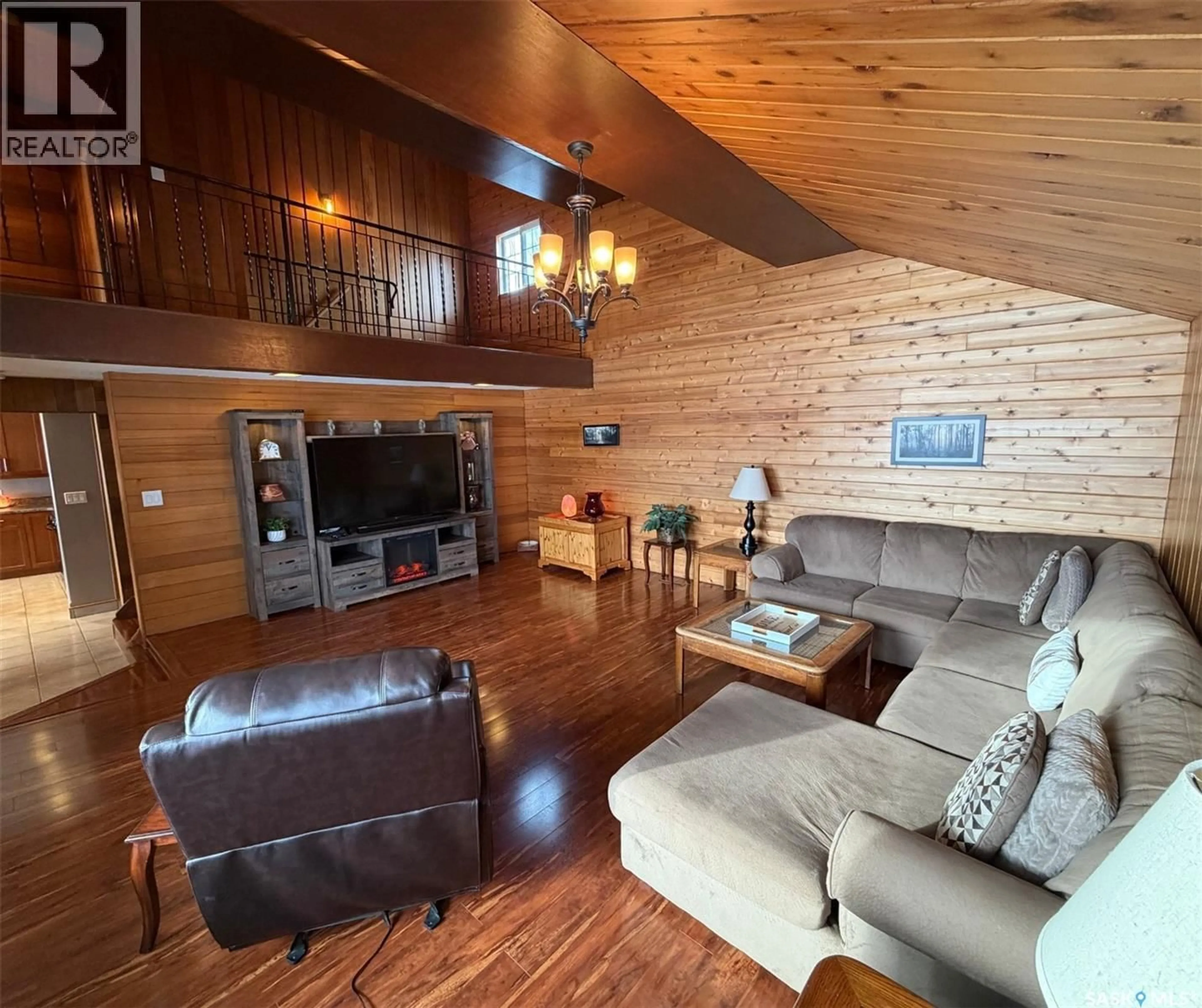 Living room with furniture, wood/laminate floor for 74 NUNN STREET, La Ronge Saskatchewan S0J1L0