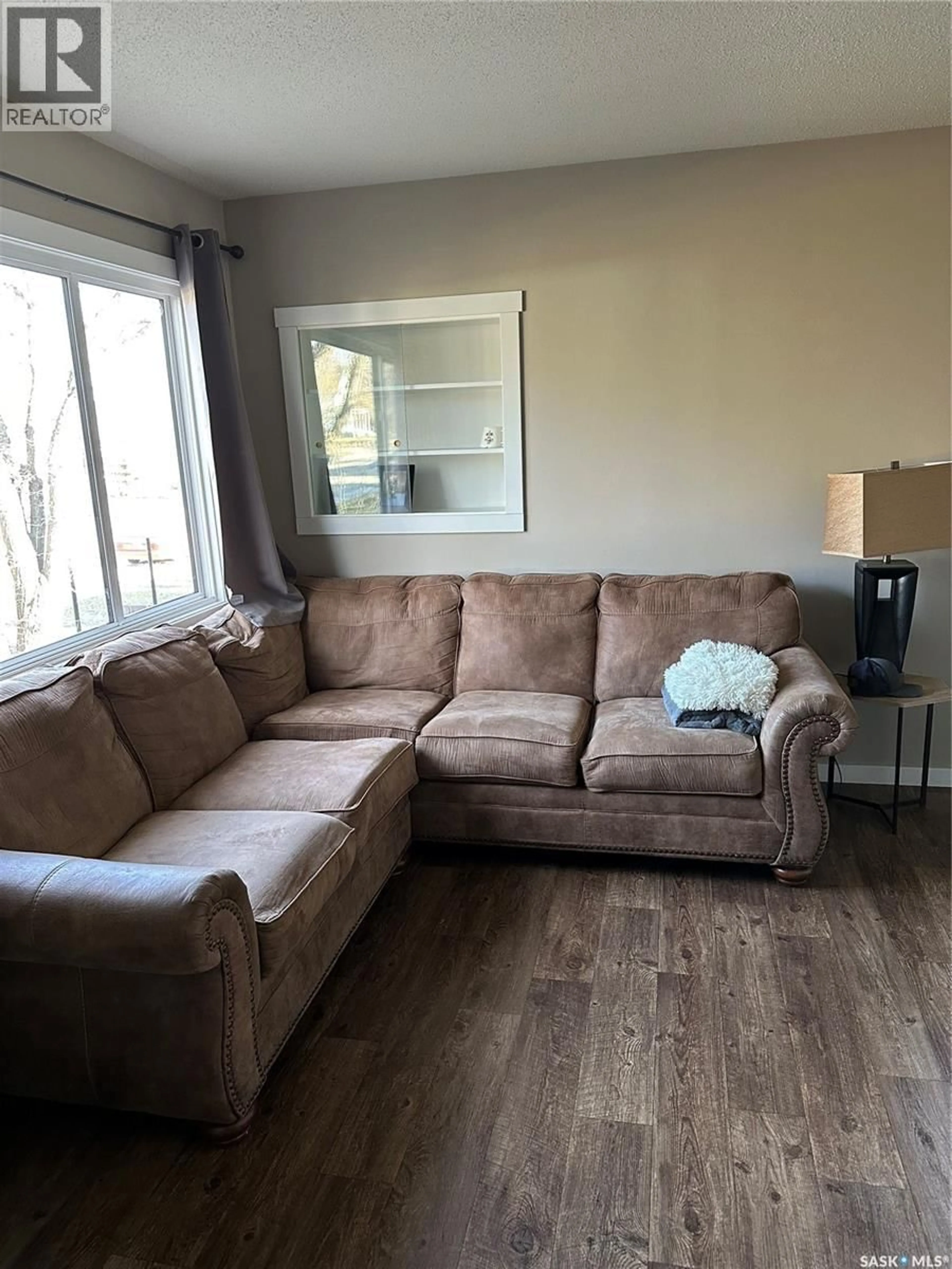 Living room with furniture, wood/laminate floor for 246 5TH AVENUE, Swift Current Saskatchewan S9H0W3