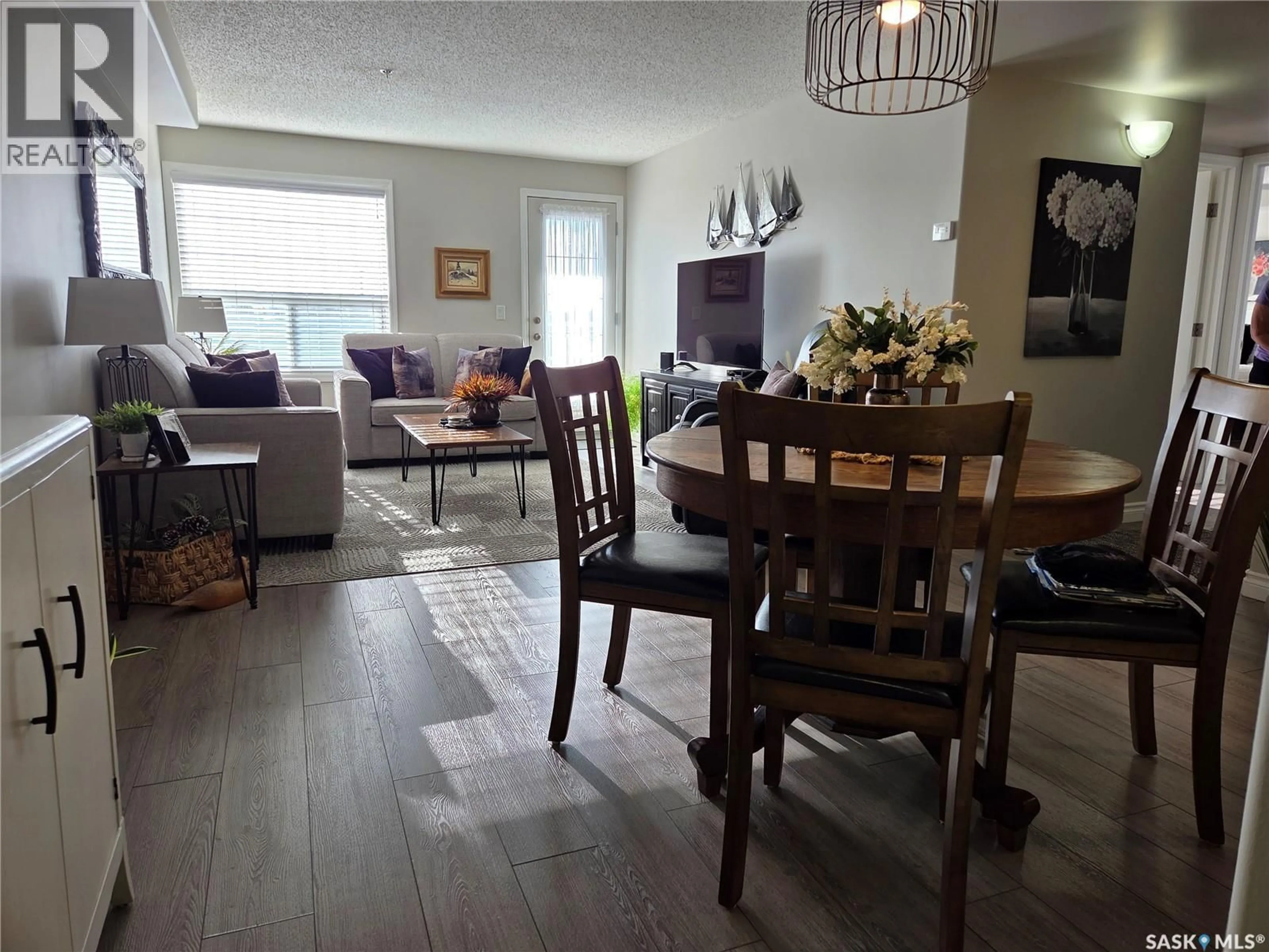 Living room with furniture, wood/laminate floor for 202 729 101ST AVENUE, Tisdale Saskatchewan S0E1T0