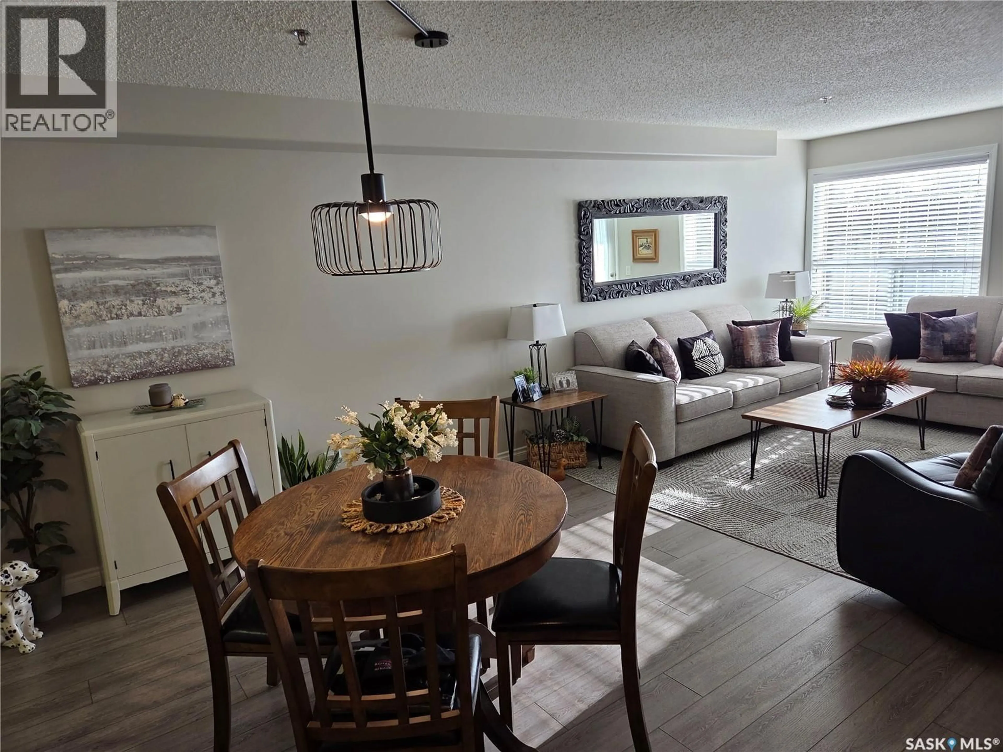 Living room with furniture, wood/laminate floor for 202 729 101ST AVENUE, Tisdale Saskatchewan S0E1T0