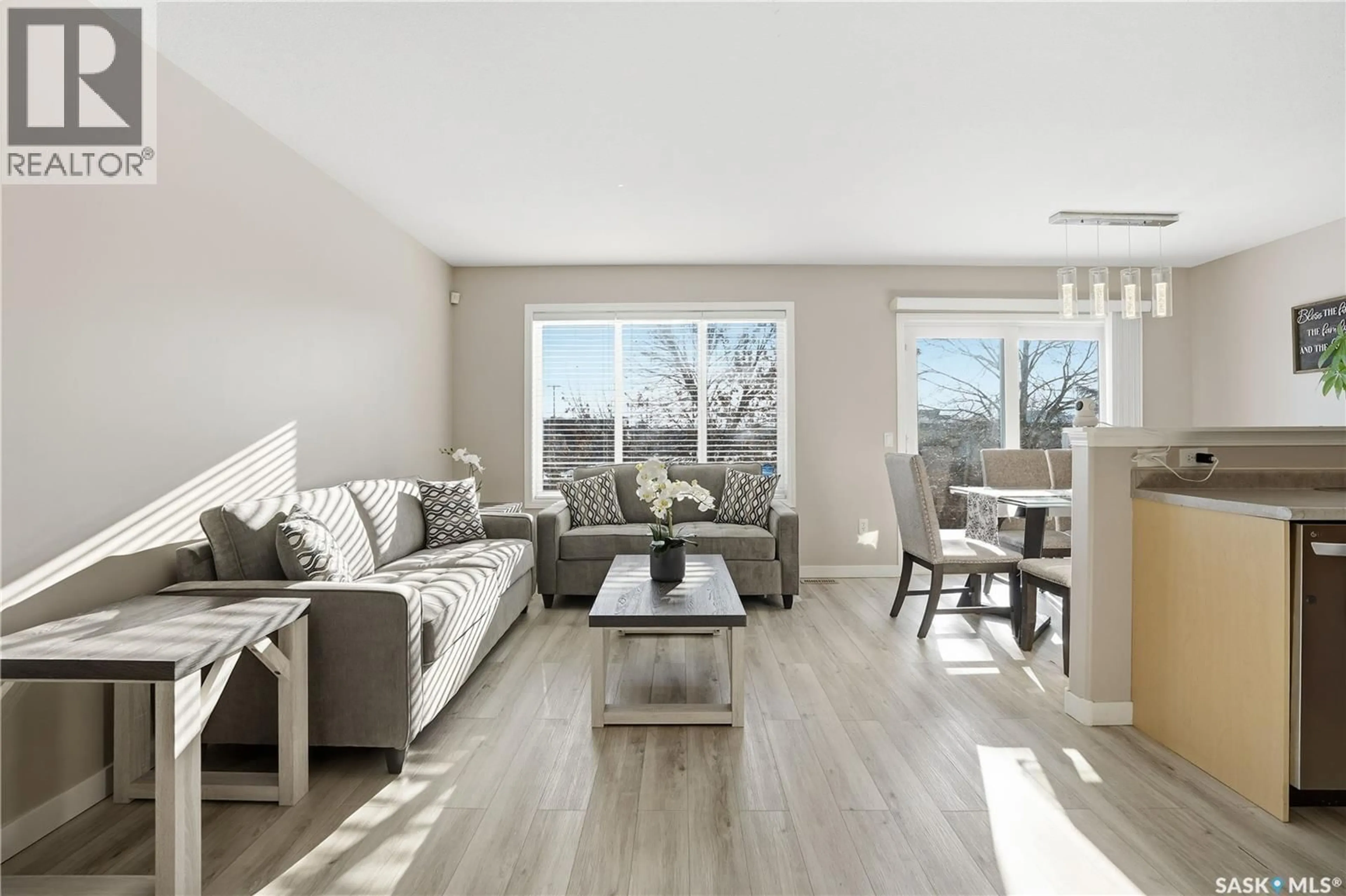 Living room with furniture, wood/laminate floor for 18 - 4425 NICURITY DRIVE, Regina Saskatchewan S4X0E6