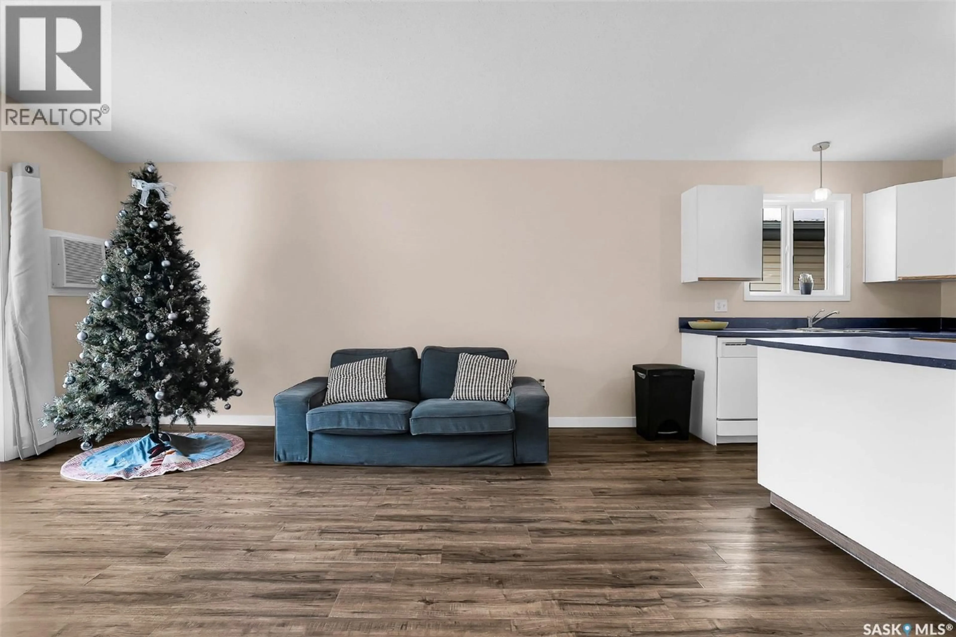 Living room with furniture, wood/laminate floor for 207 HAICHERT STREET, Warman Saskatchewan S0K4S0