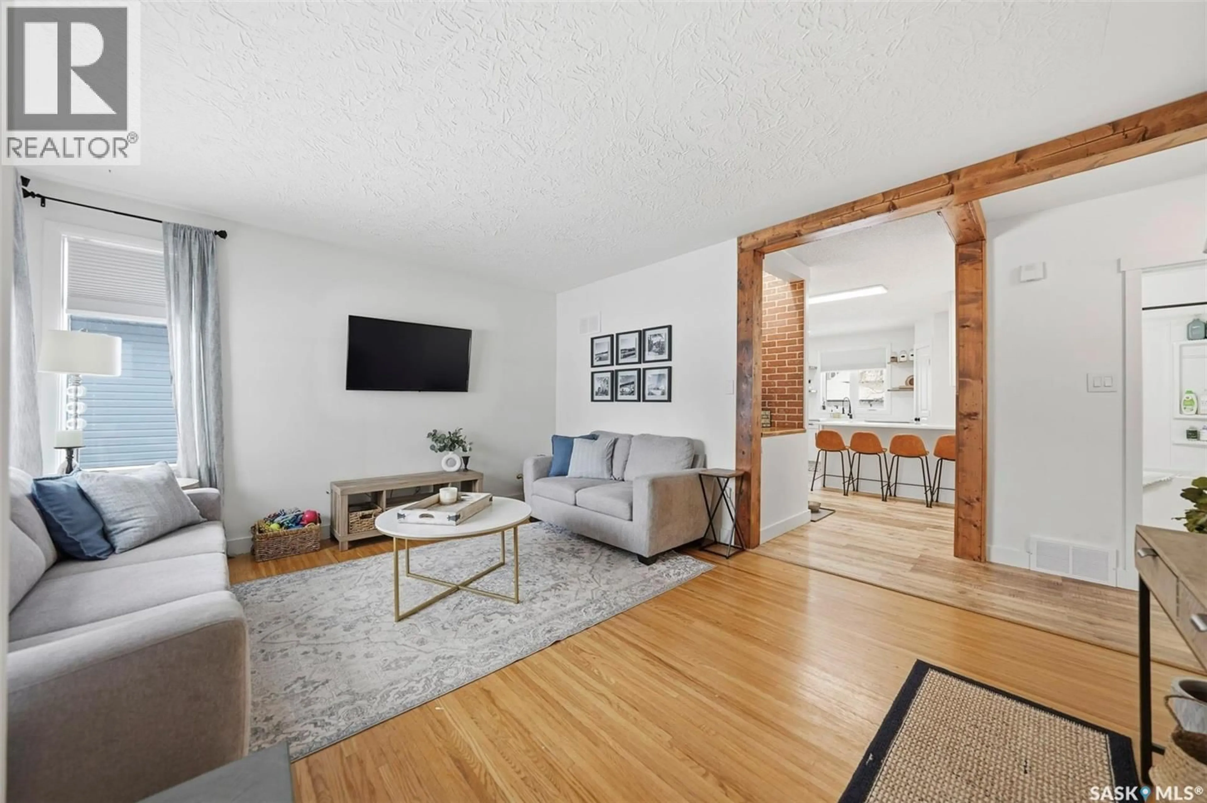 Living room with furniture, wood/laminate floor for 1622 CAIRNS AVENUE, Saskatoon Saskatchewan S7H2H8