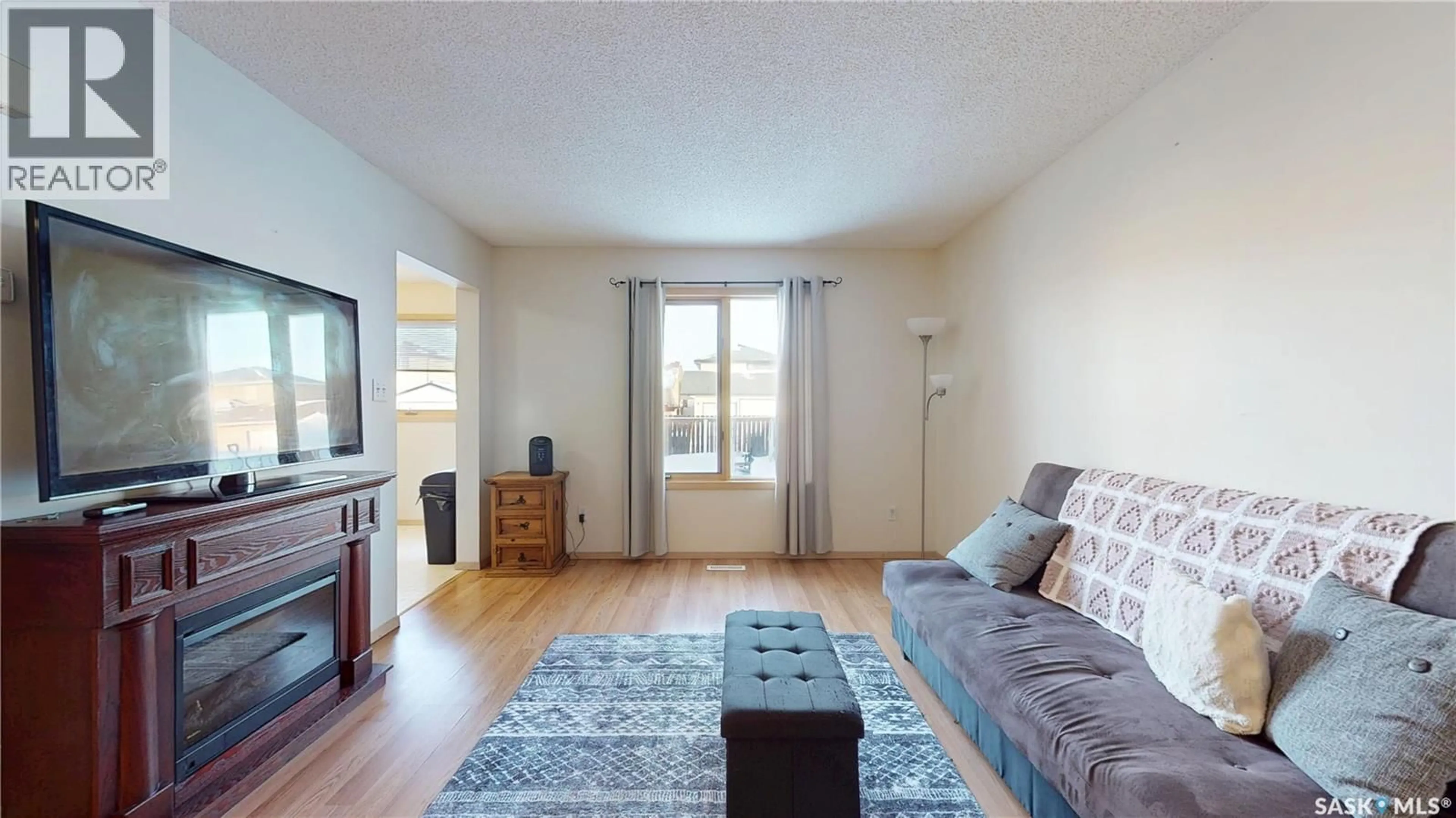 Living room with furniture, wood/laminate floor for 3876 7TH AVENUE, Regina Saskatchewan S4N7K8