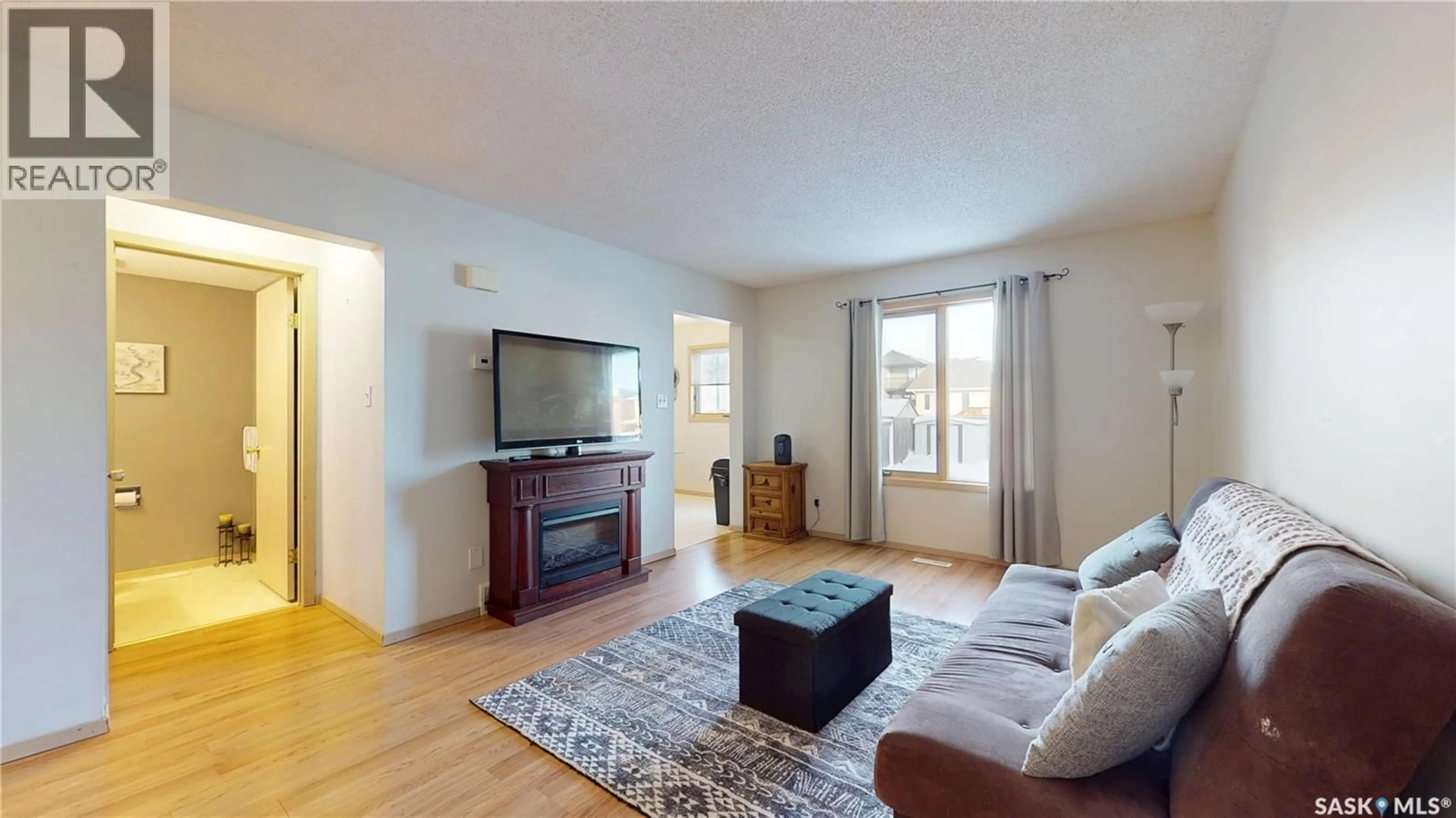 Living room with furniture, wood/laminate floor for 3876 7TH AVENUE, Regina Saskatchewan S4N7K8