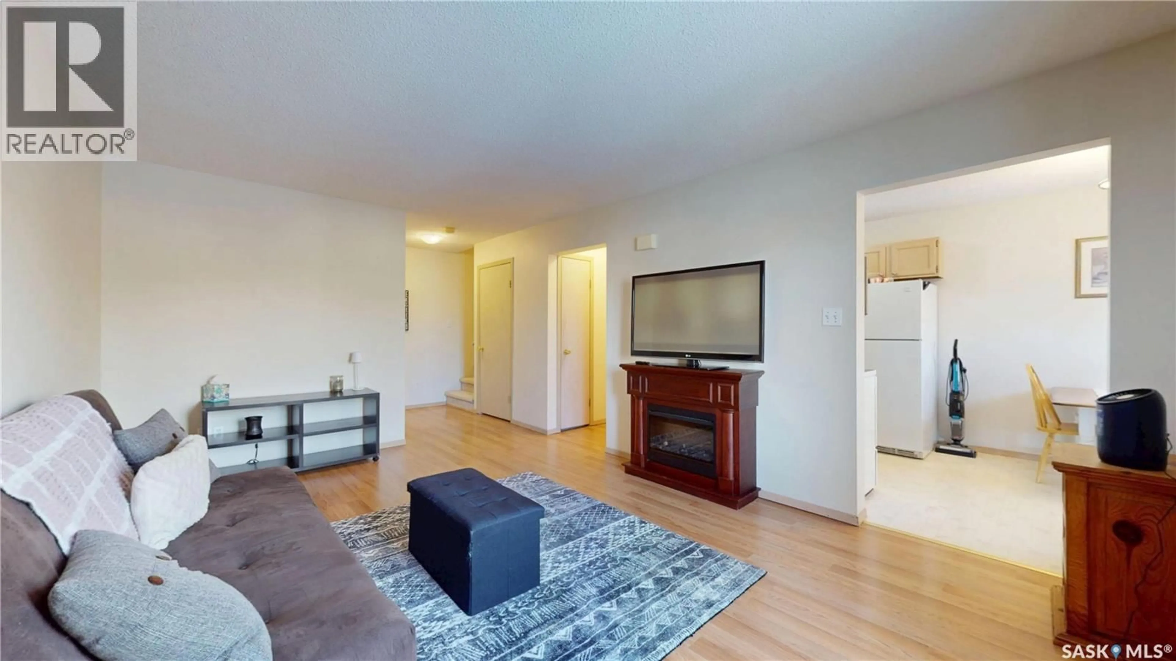 Living room with furniture, wood/laminate floor for 3876 7TH AVENUE, Regina Saskatchewan S4N7K8