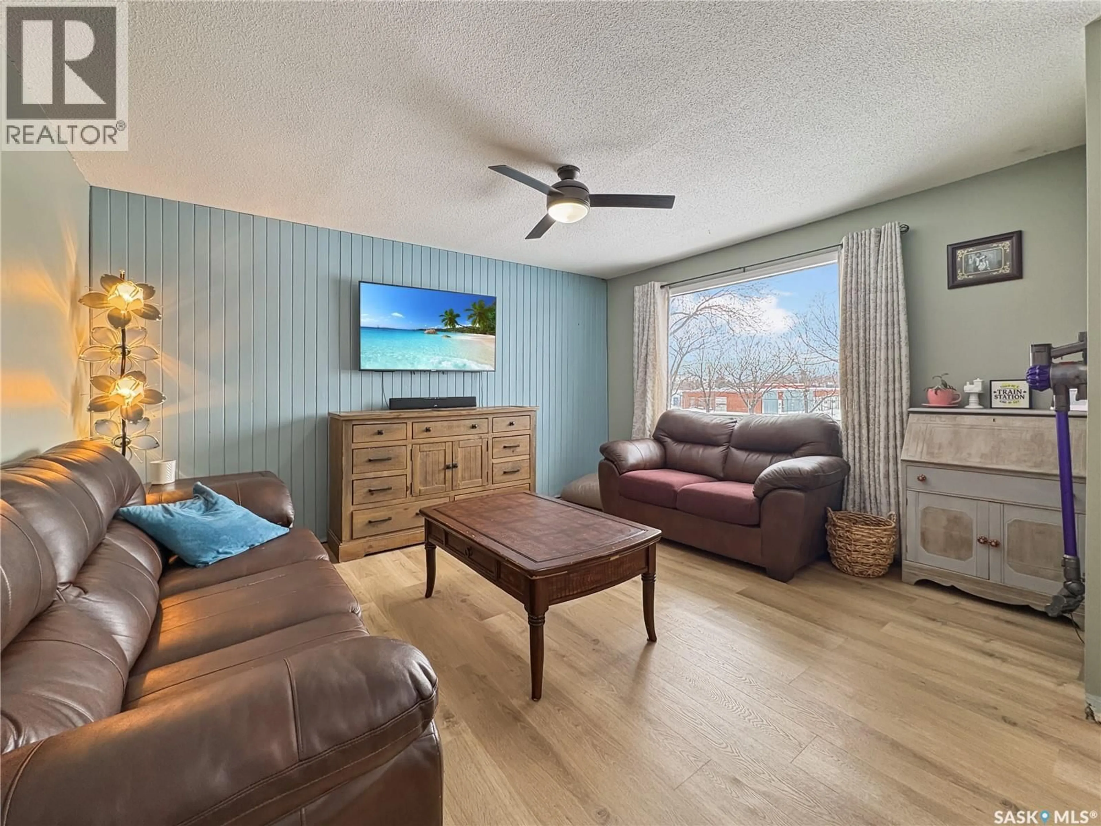 Living room with furniture, wood/laminate floor for 1962 101ST STREET, North Battleford Saskatchewan S9A1B3