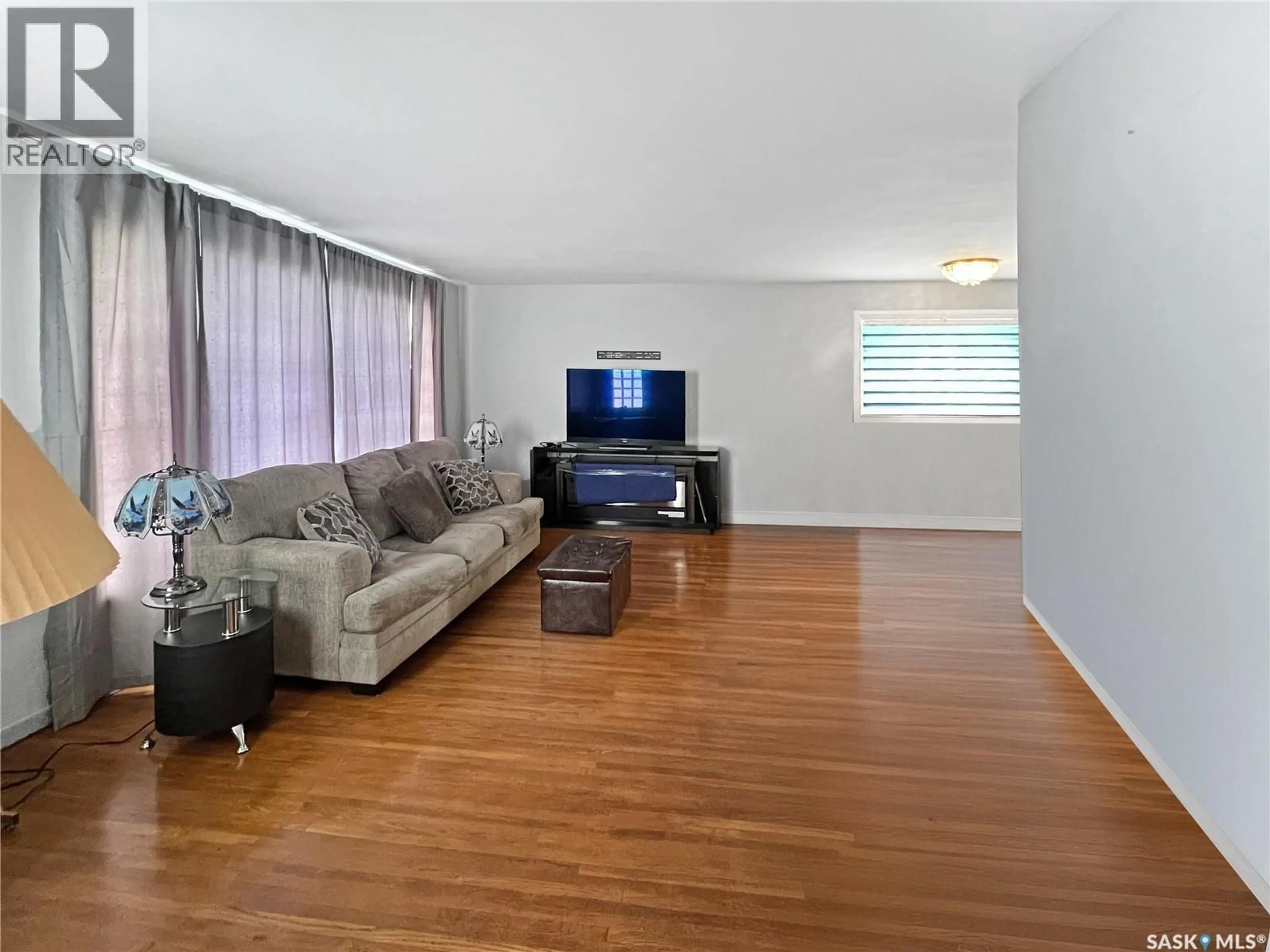 Living room with furniture, wood/laminate floor for 596 1ST AVENUE, Swift Current Saskatchewan S9H2B7