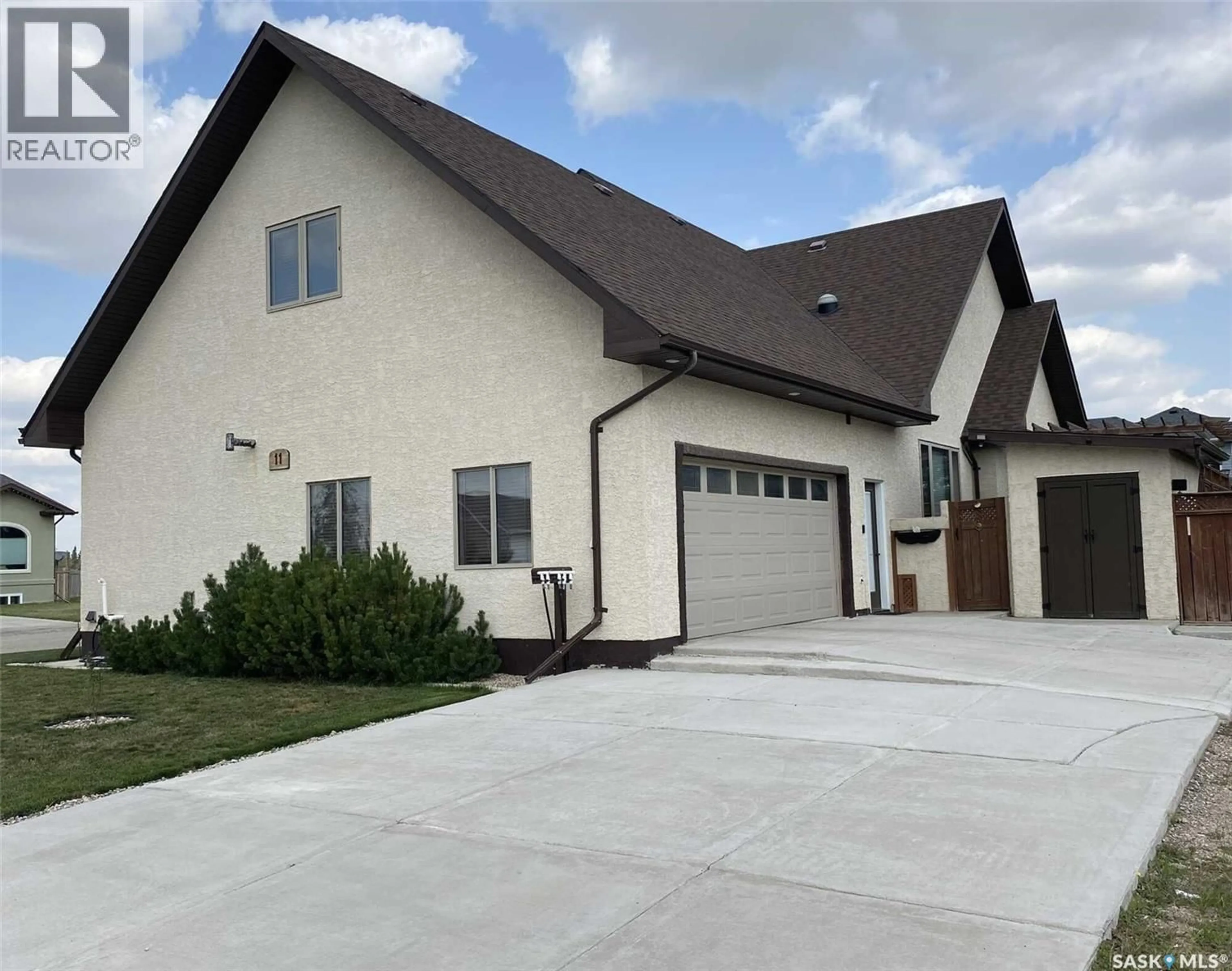 Home with vinyl exterior material, street for 11 ROBERTSON ROAD, Lanigan Saskatchewan S0K2M0