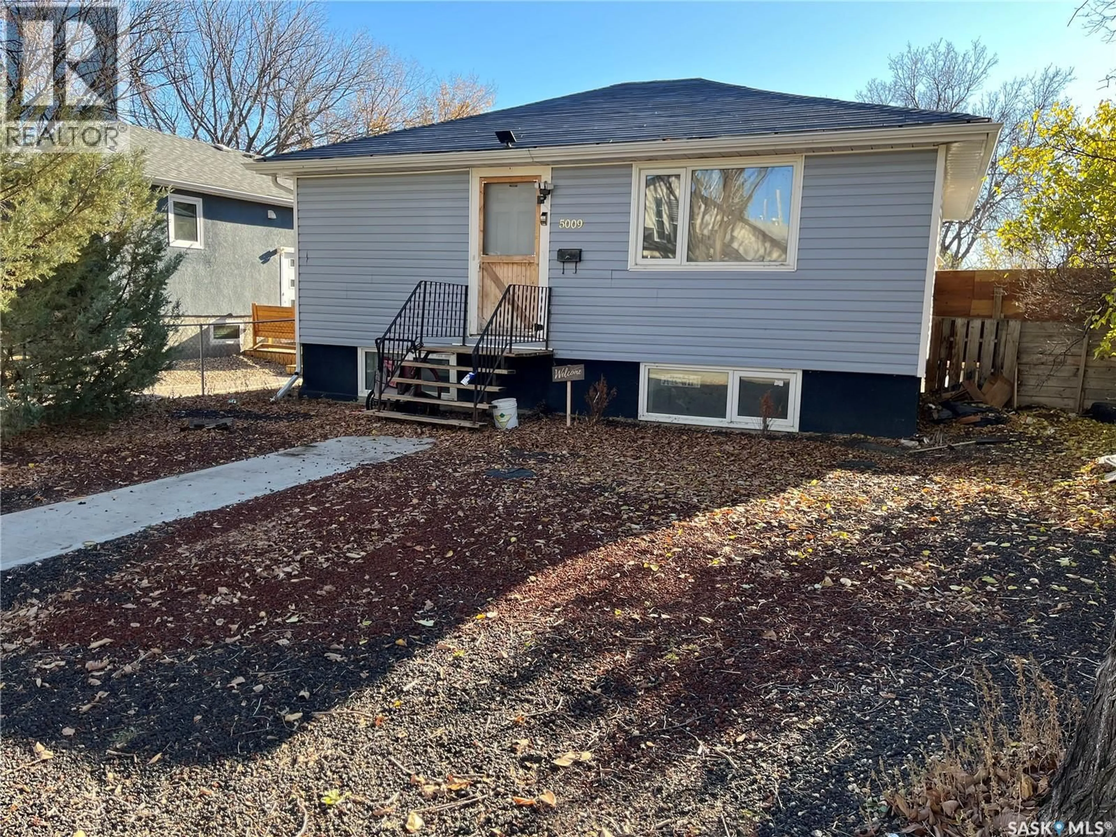 Home with vinyl exterior material, street for 5009 8TH AVENUE, Regina Saskatchewan S4T0W4