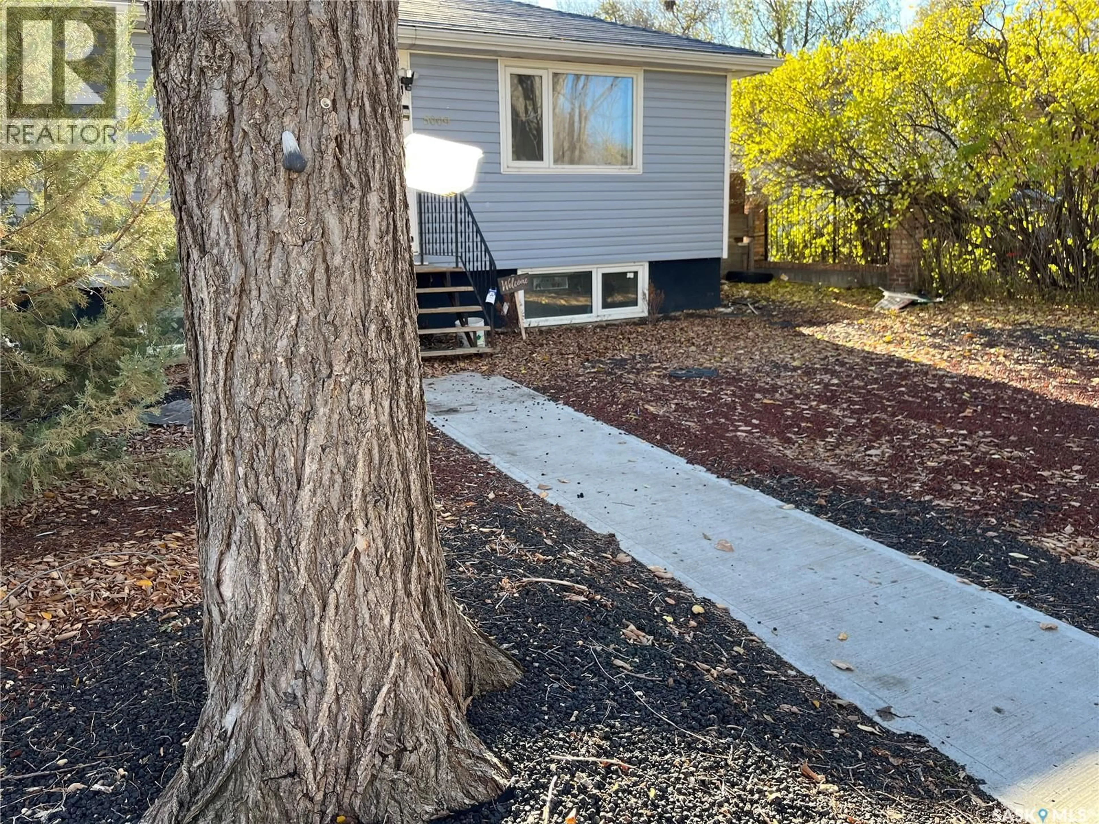 Home with vinyl exterior material, street for 5009 8TH AVENUE, Regina Saskatchewan S4T0W4