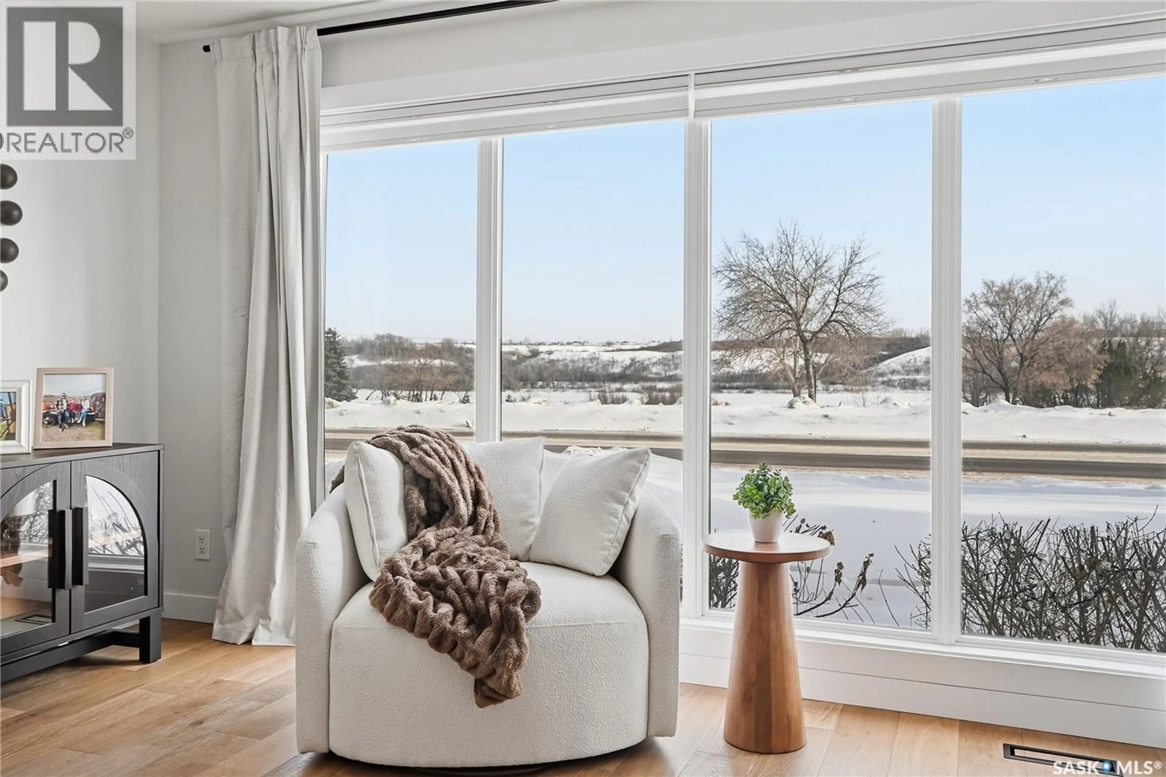 Living room with furniture, wood/laminate floor for 115 WHITESWAN DRIVE, Saskatoon Saskatchewan S7K4M5