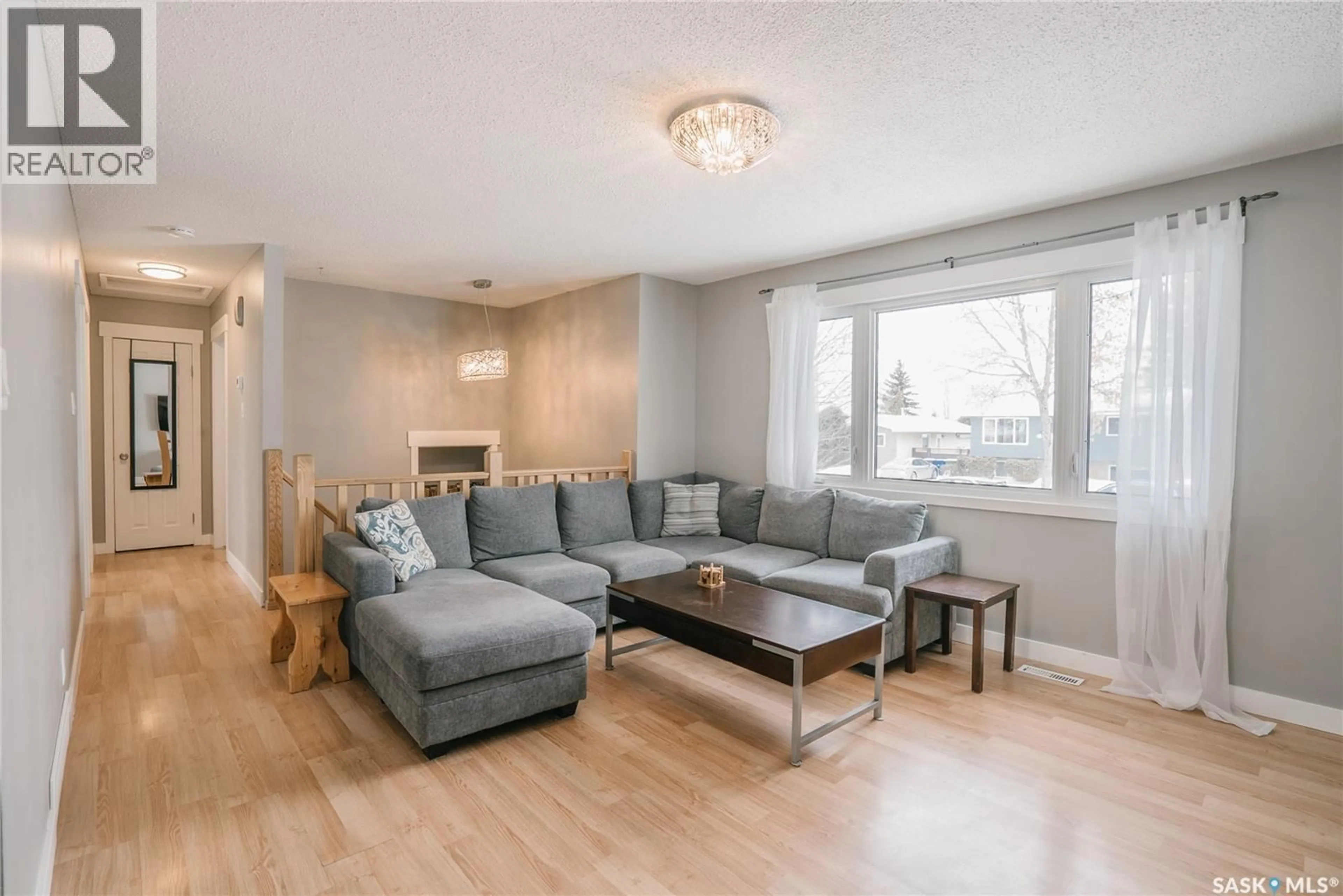 Living room with furniture, wood/laminate floor for 346 BROCK CRESCENT, Saskatoon Saskatchewan S7H4N5