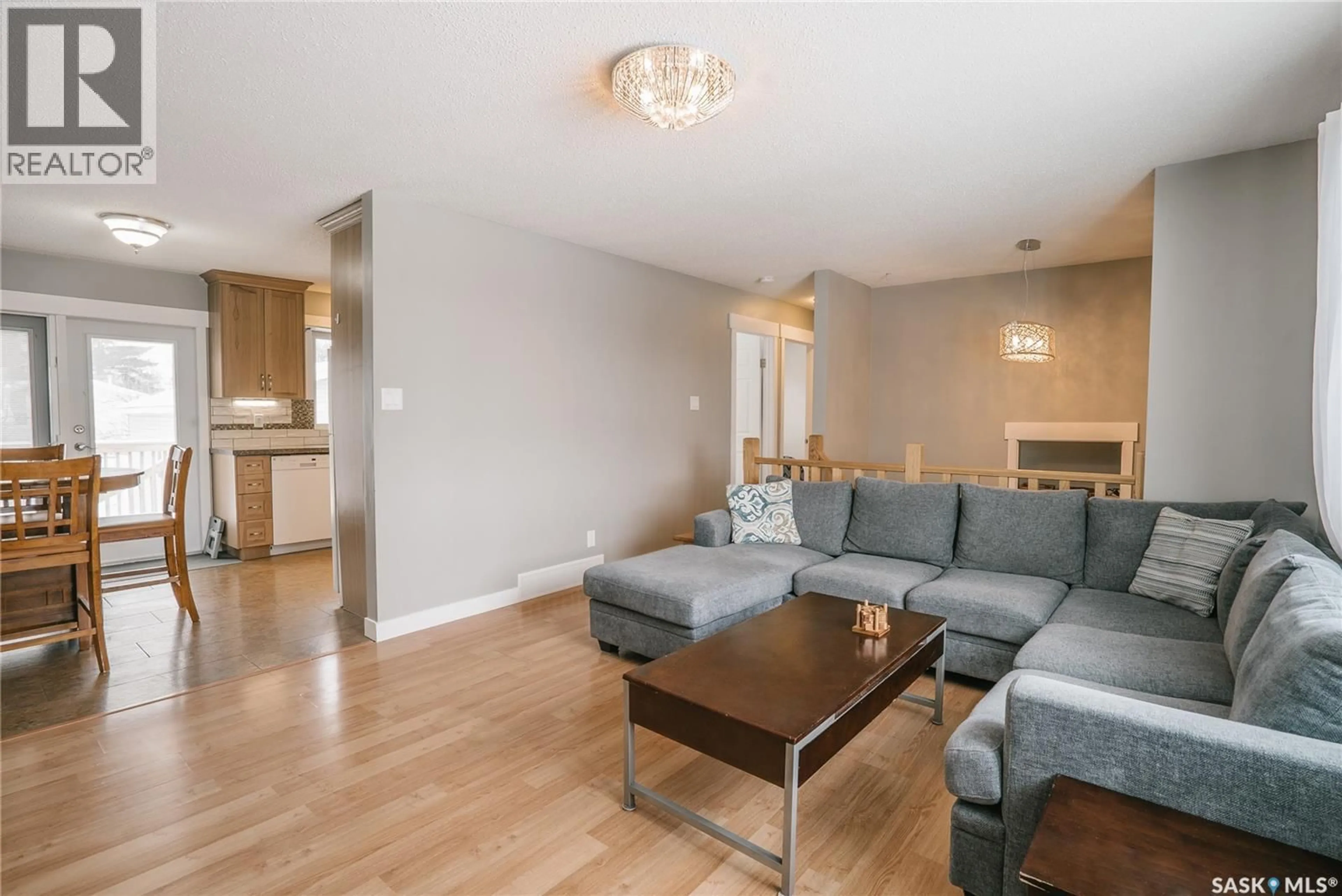 Living room with furniture, wood/laminate floor for 346 BROCK CRESCENT, Saskatoon Saskatchewan S7H4N5