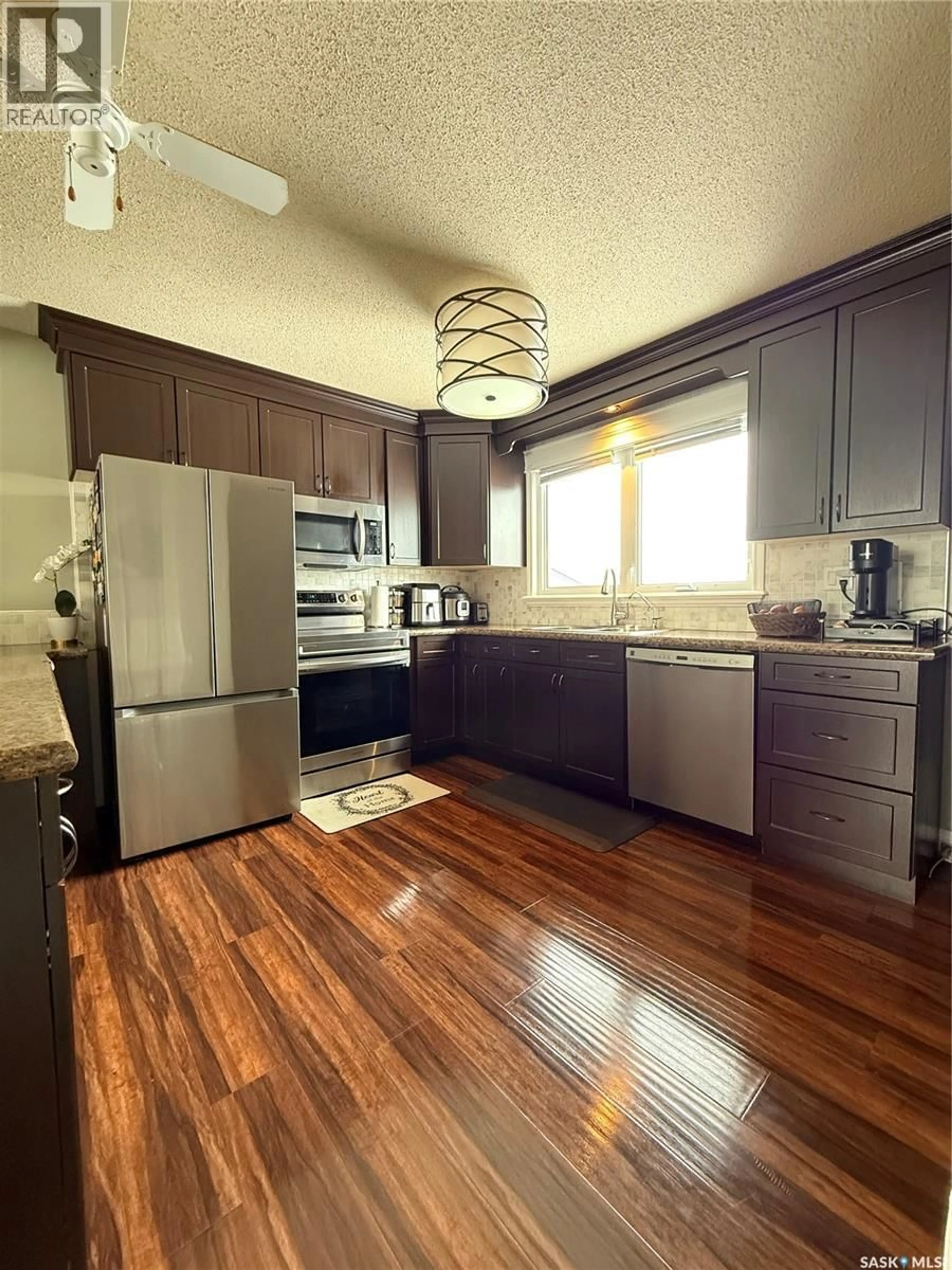 Open concept kitchen, wood/laminate floor for 35 COLLACOTT DRIVE, Yorkton Saskatchewan S3N3E5