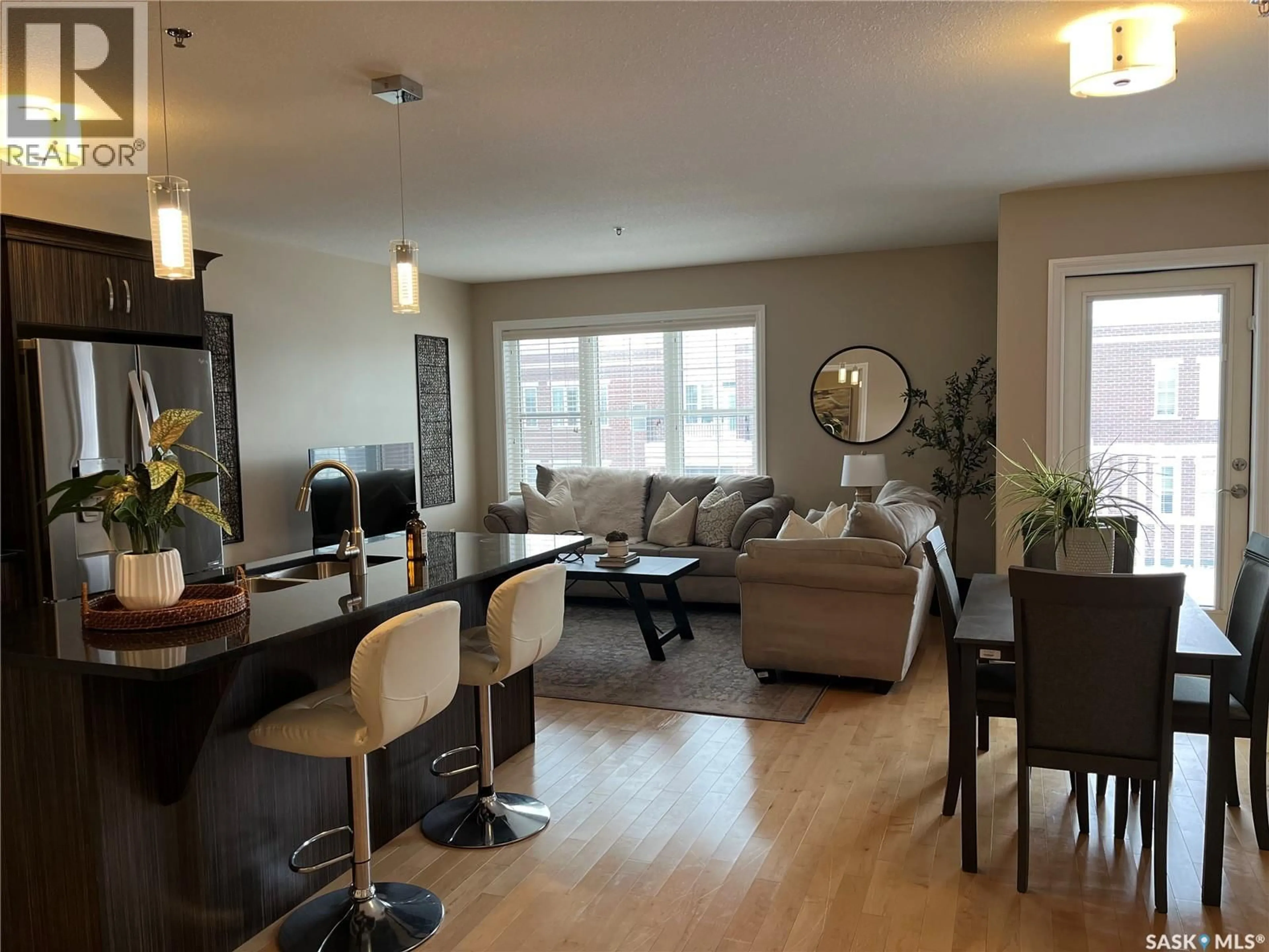 Living room with furniture, wood/laminate floor for 320 1715 BADHAM BOULEVARD, Regina Saskatchewan S4P0M9