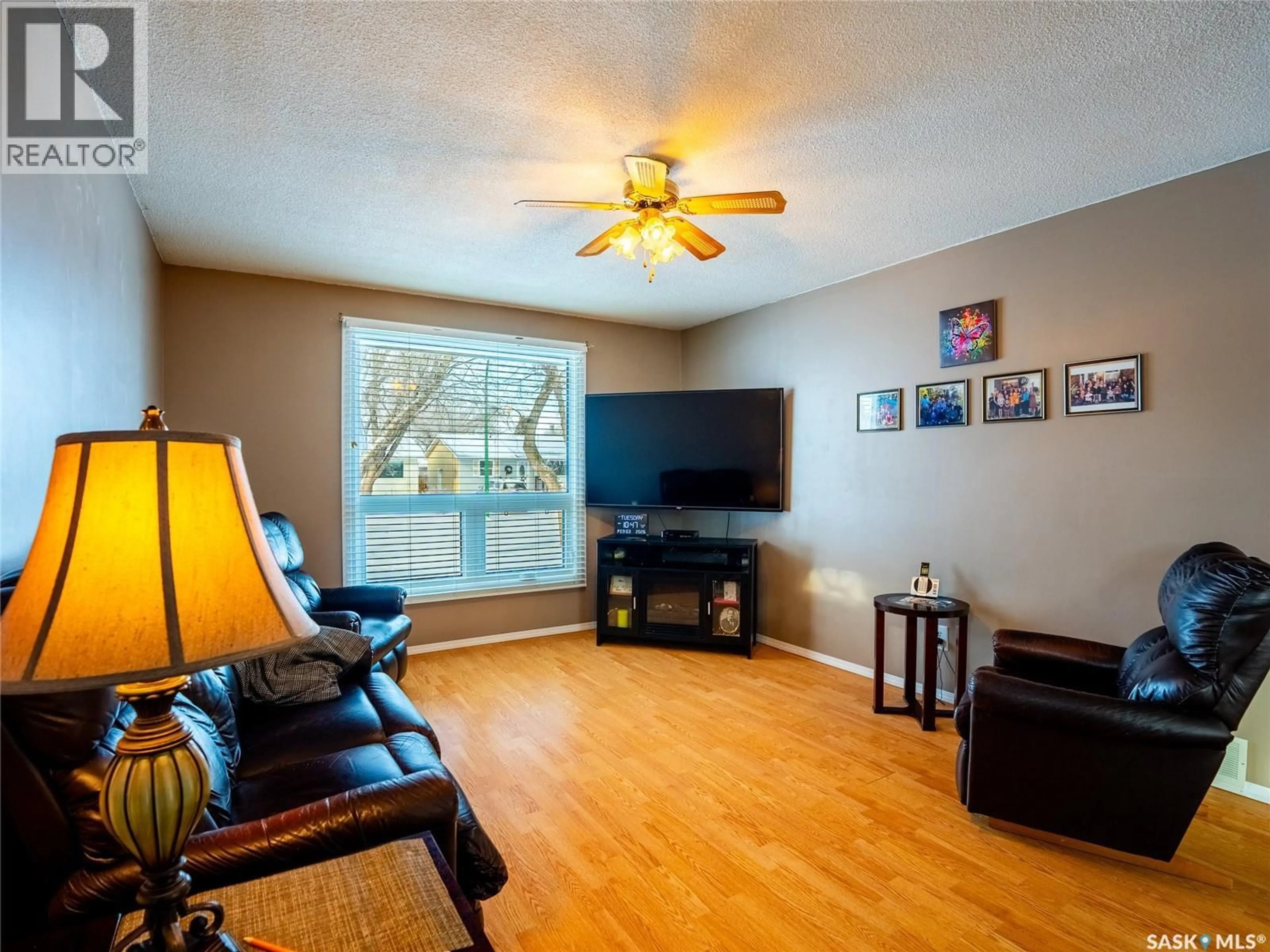 Living room with furniture, wood/laminate floor for 318 FORSYTH CRESCENT, Regina Saskatchewan S4R5L5