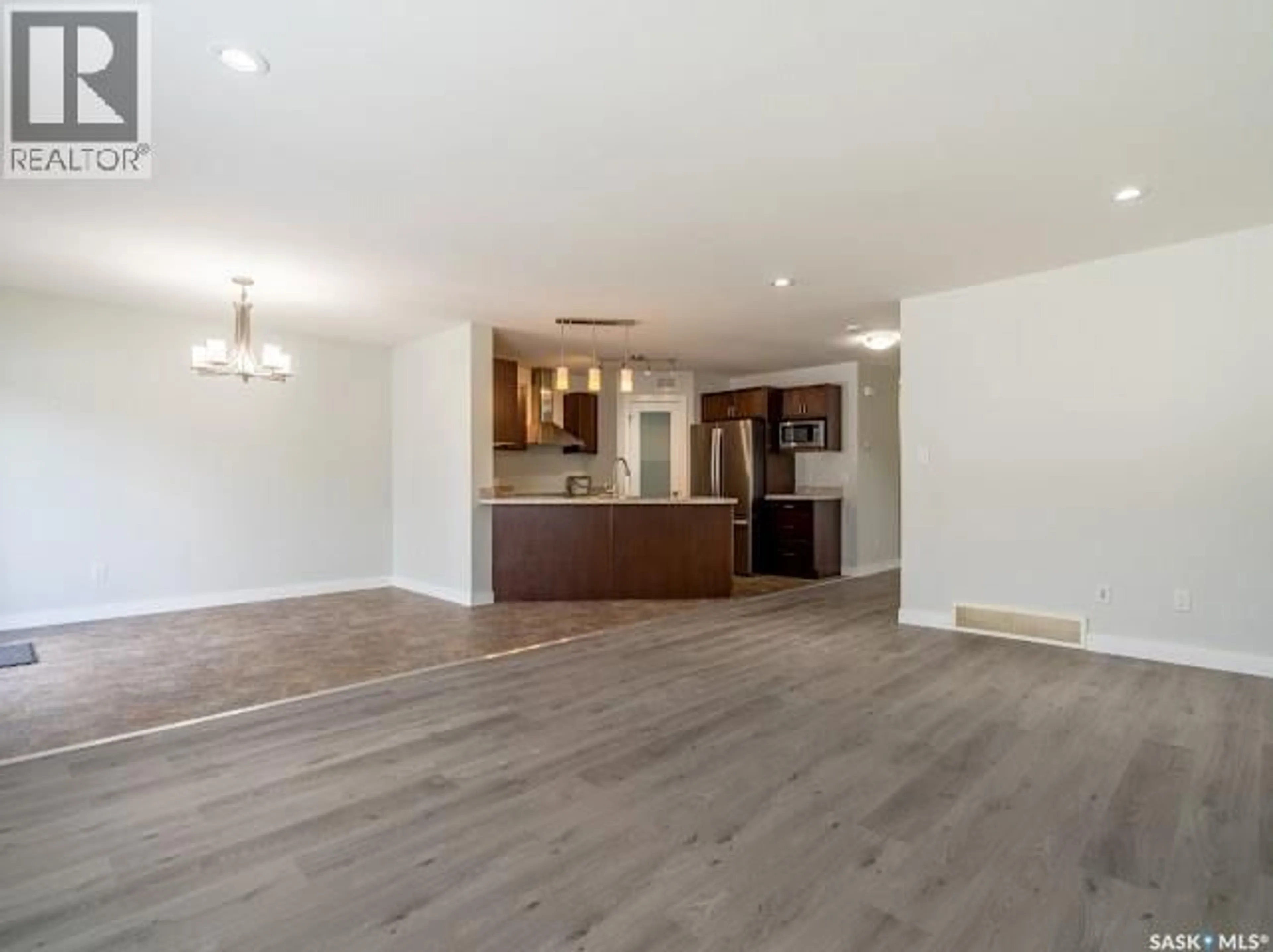 Open concept kitchen, wood/laminate floor for 5102 SNOWBIRDS CRESCENT, Regina Saskatchewan S0G4G0