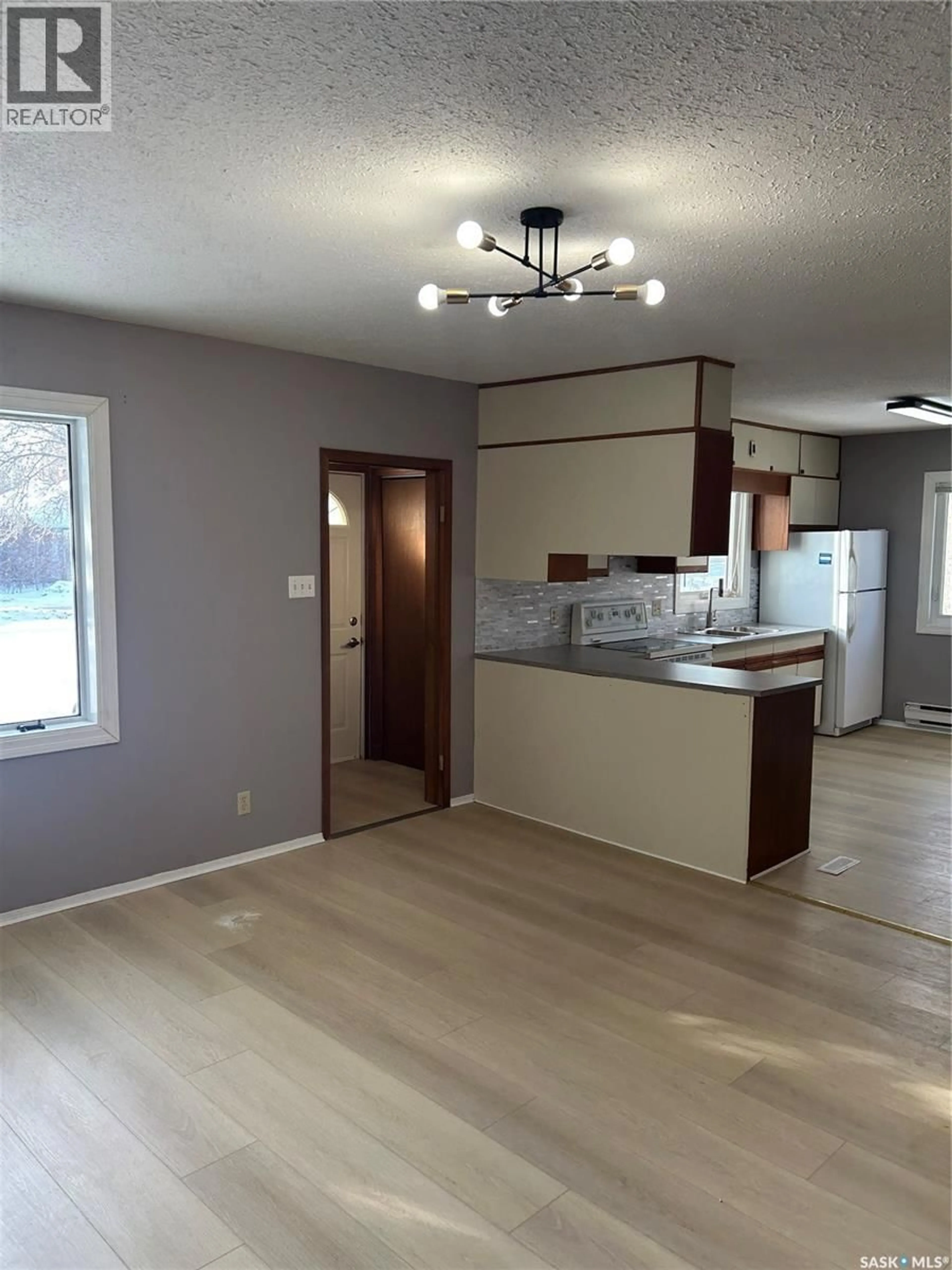 Open concept kitchen, wood/laminate floor for 522 8TH STREET, Prince Albert Saskatchewan S6V0W6