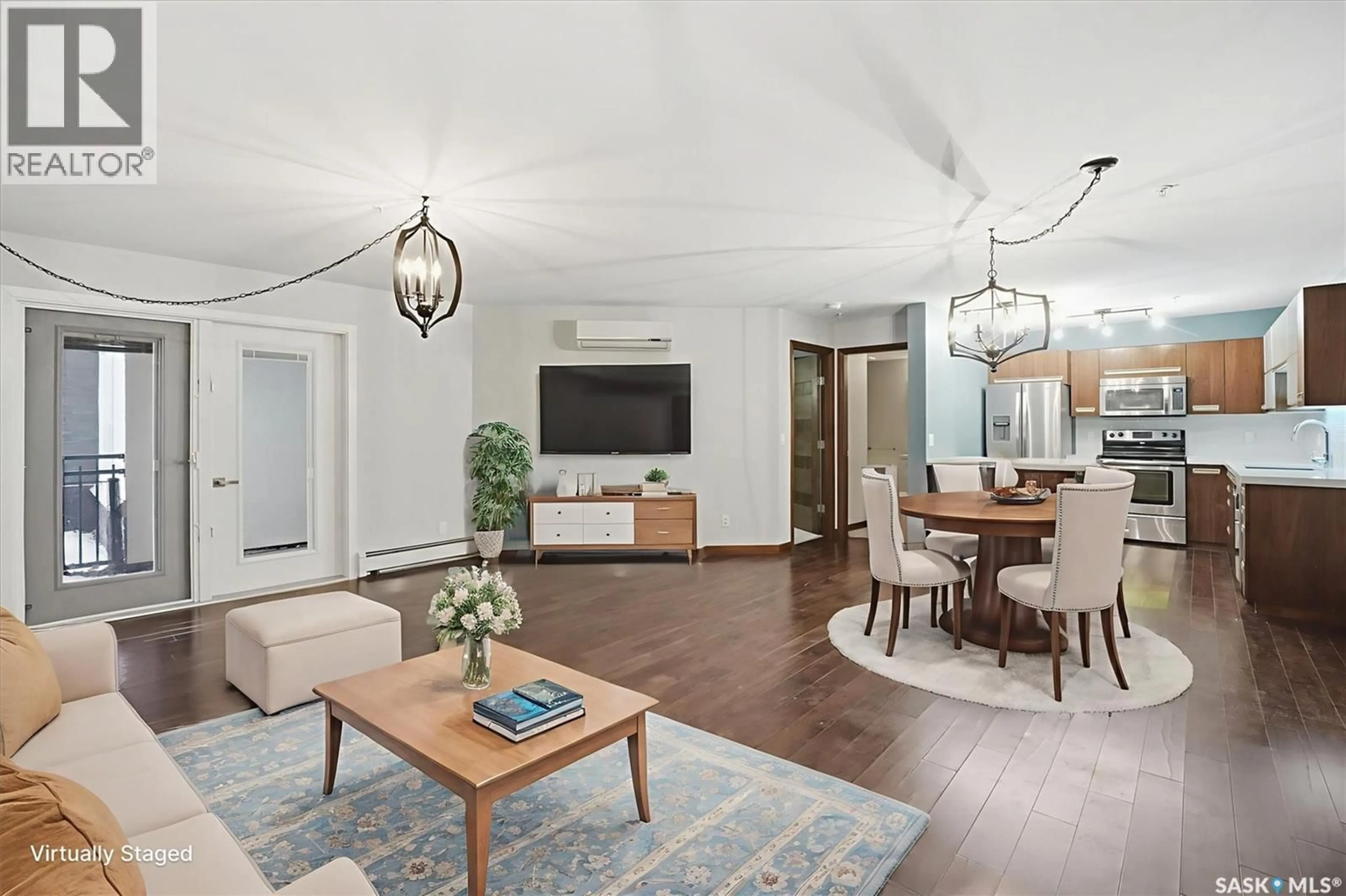 Living room with furniture, wood/laminate floor for 112 130 PHELPS WAY, Saskatoon Saskatchewan S7V0K5