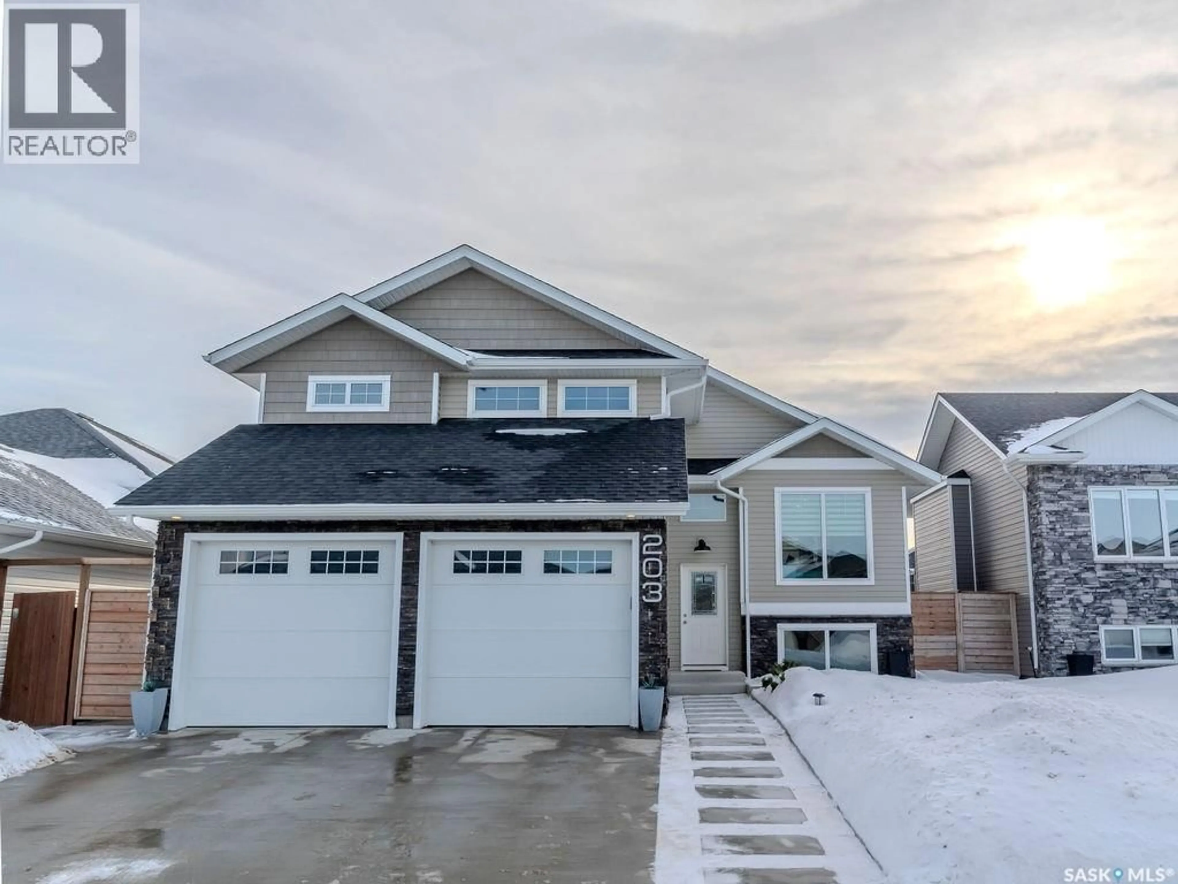 Home with vinyl exterior material, street for 203 SETTLER CRESCENT, Warman Saskatchewan S0K4S5