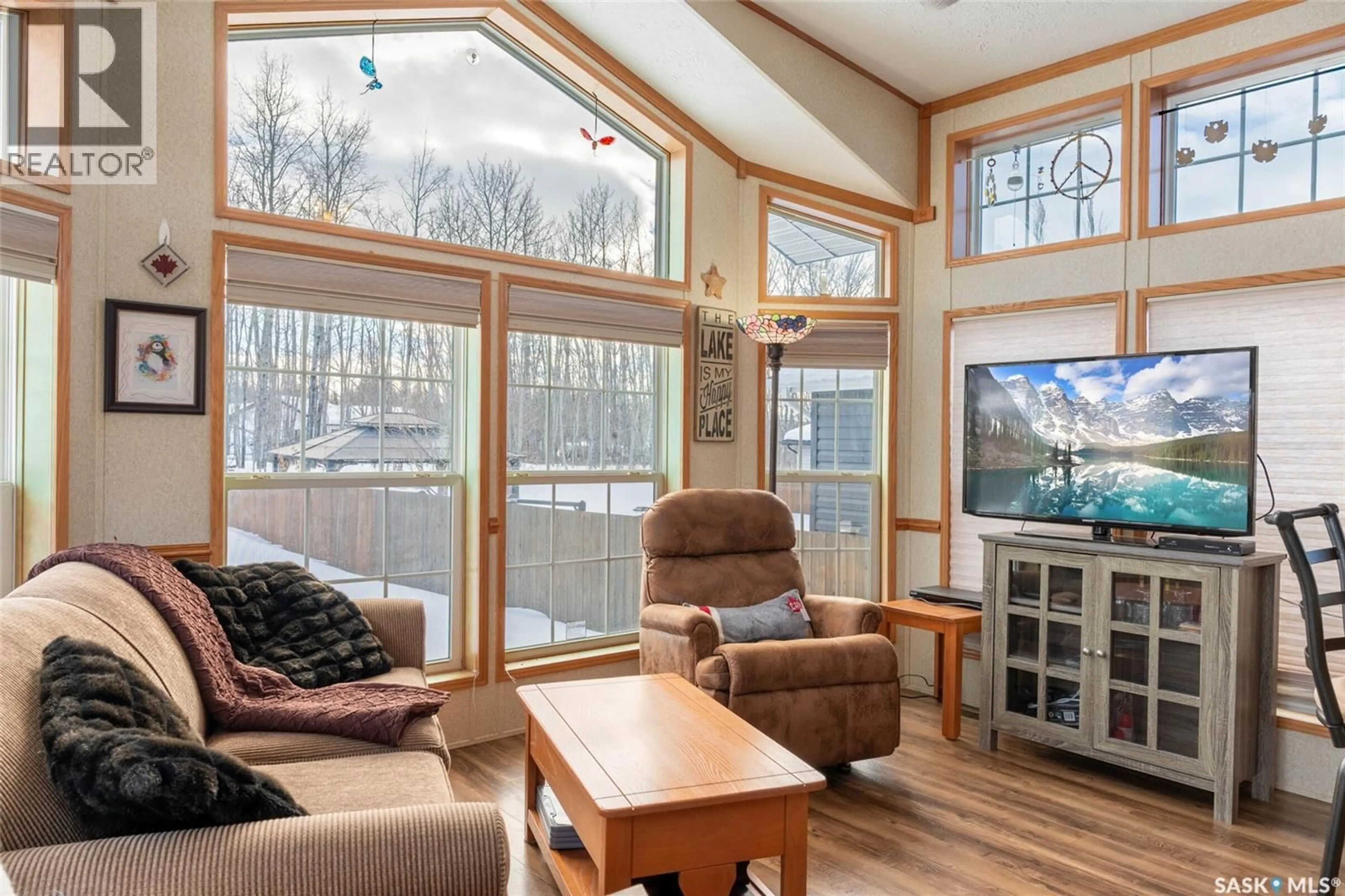 Living room with furniture, wood/laminate floor for 1209 OAK AVENUE, Lac des Îles Saskatchewan S0M1A0