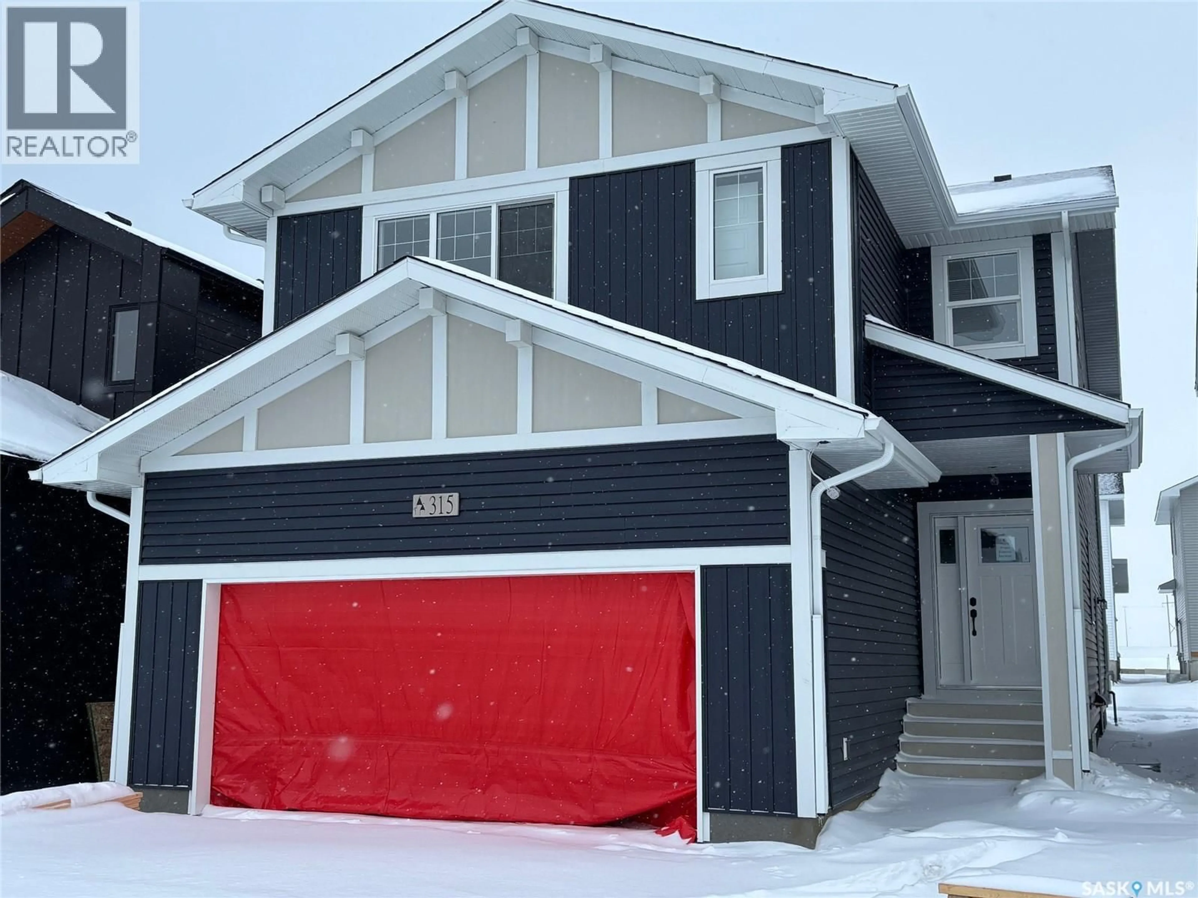 Home with vinyl exterior material, street for 315 ASOKAN BEND, Saskatoon Saskatchewan S7V1V7