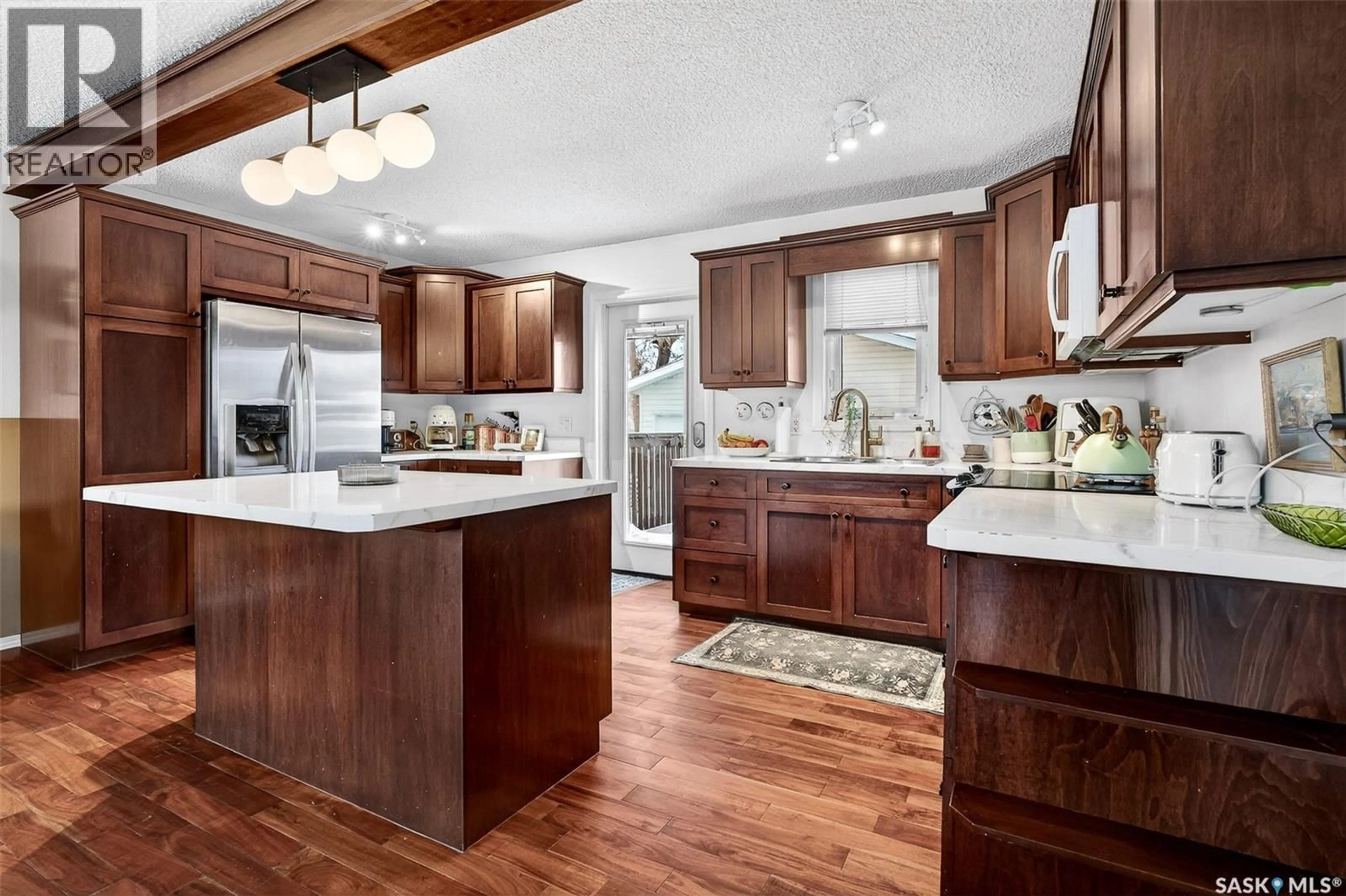 Open concept kitchen, wood/laminate floor for 1519 GRANDVIEW STREET, Moose Jaw Saskatchewan S6H6R4