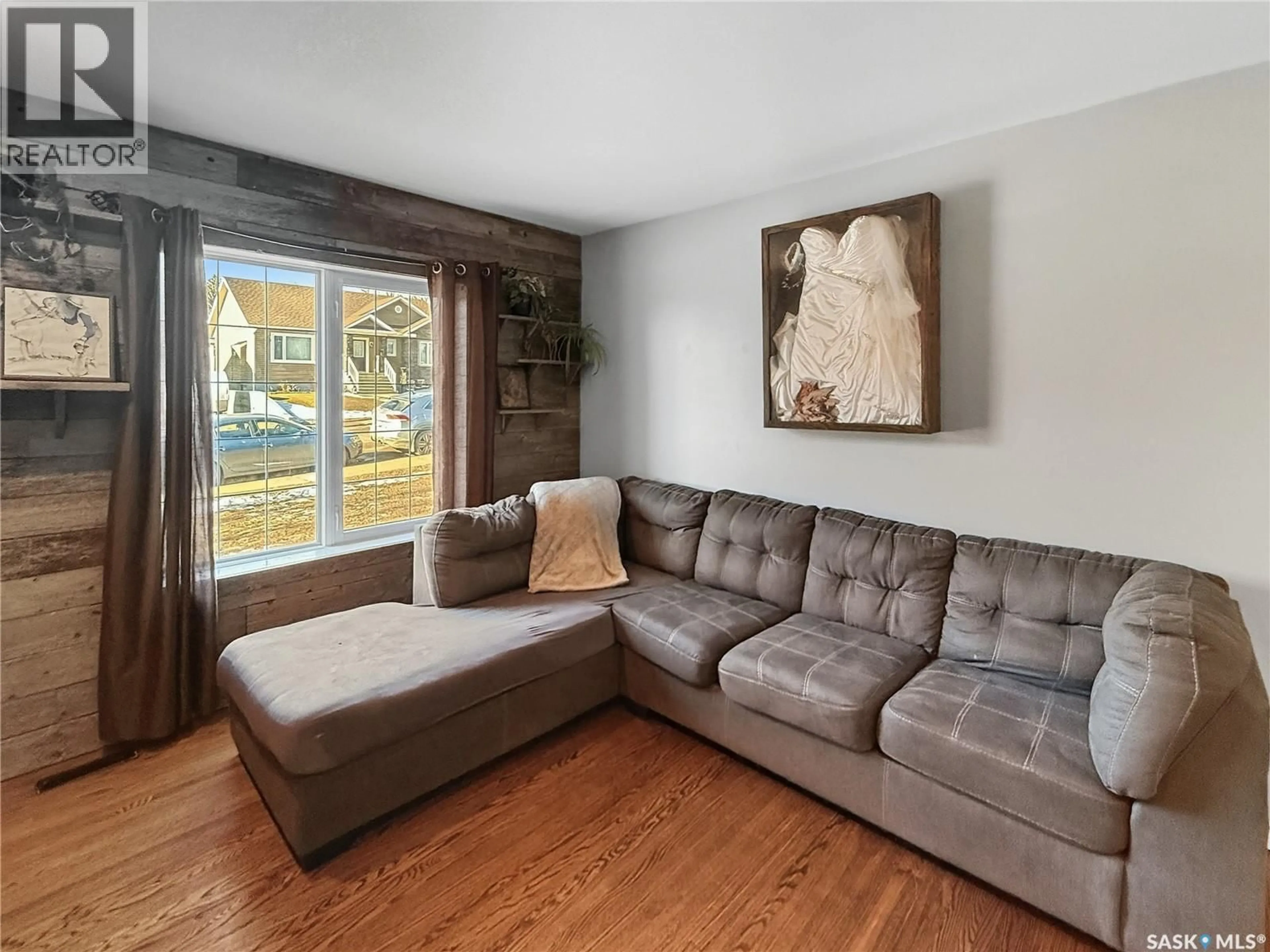 Living room with furniture, wood/laminate floor for 545 1ST AVENUE, Swift Current Saskatchewan S9H2B8