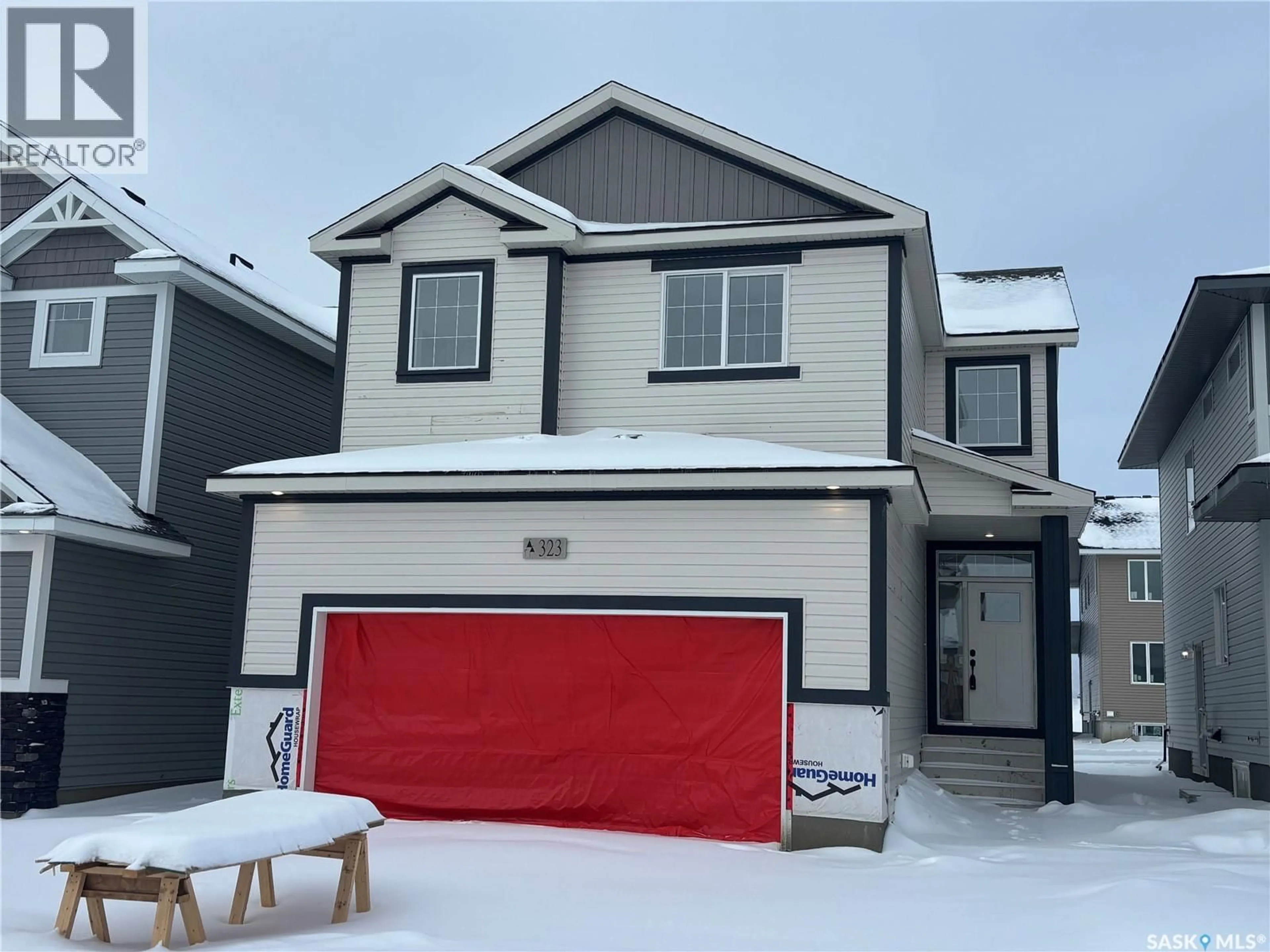 Home with vinyl exterior material, street for 323 ASOKAN BEND, Saskatoon Saskatchewan S7V1V7