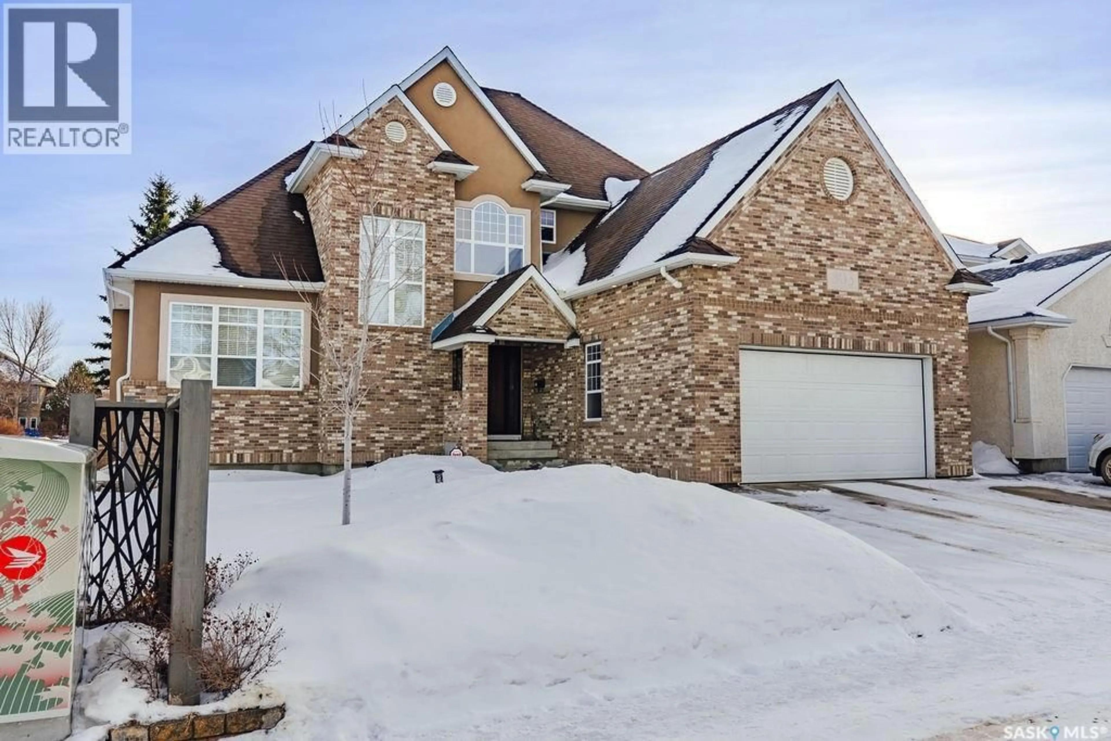 Home with brick exterior material, street for 303 ADASKIN COVE, Saskatoon Saskatchewan S7N4P3