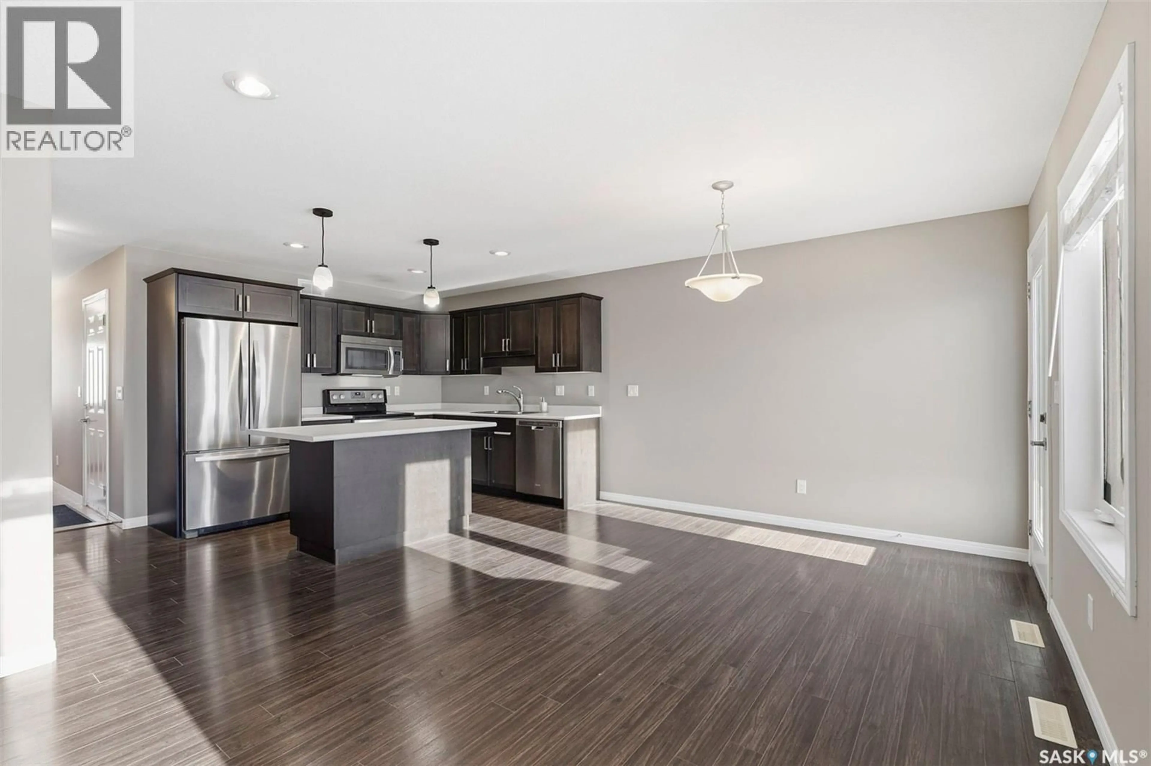 Open concept kitchen, wood/laminate floor for 7 DAWSON CRESCENT, Saskatoon Saskatchewan S7R0K1