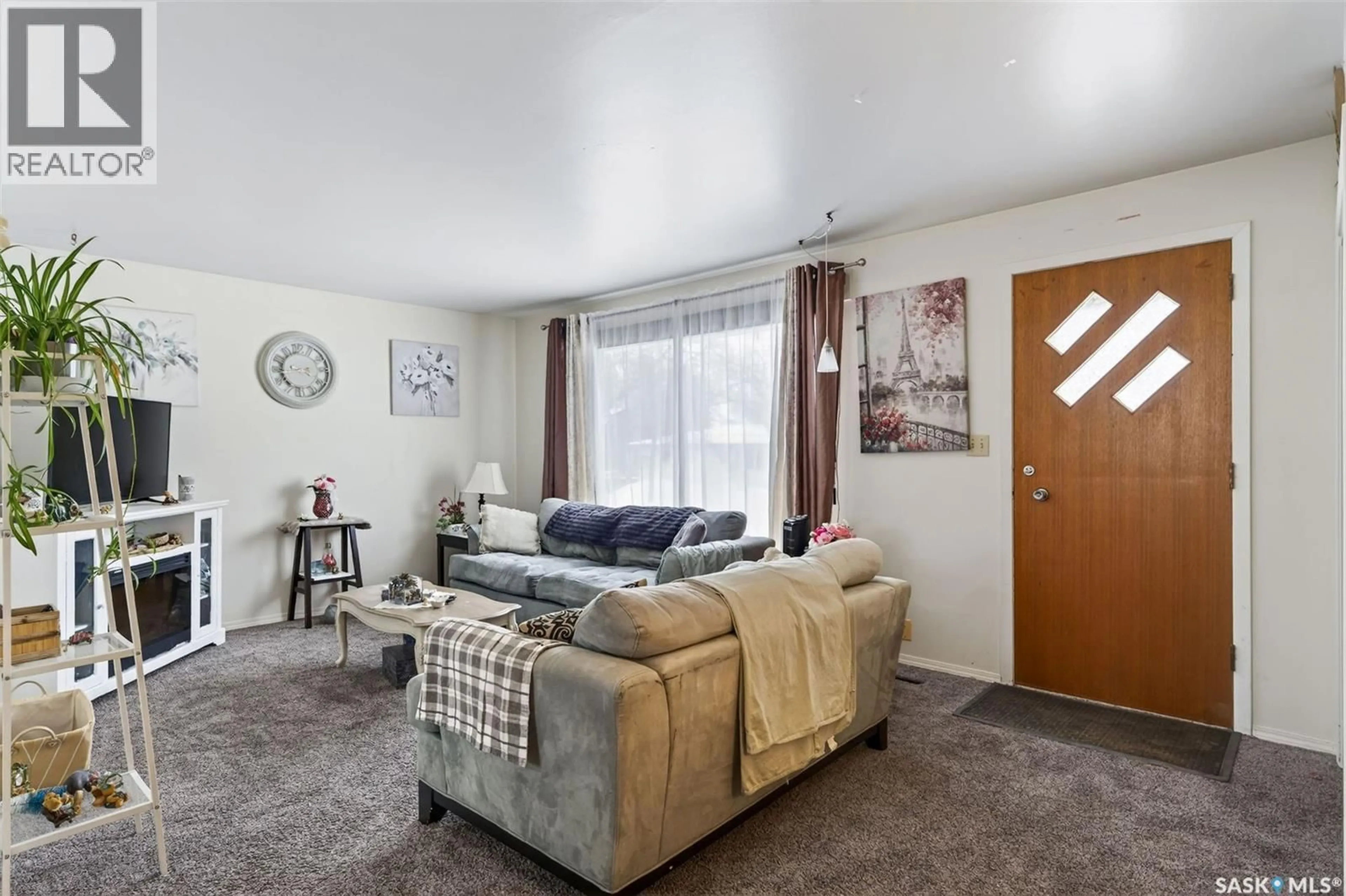 Living room with furniture, carpet floor for 214 HIGGINS AVENUE, Melfort Saskatchewan S0E1A0